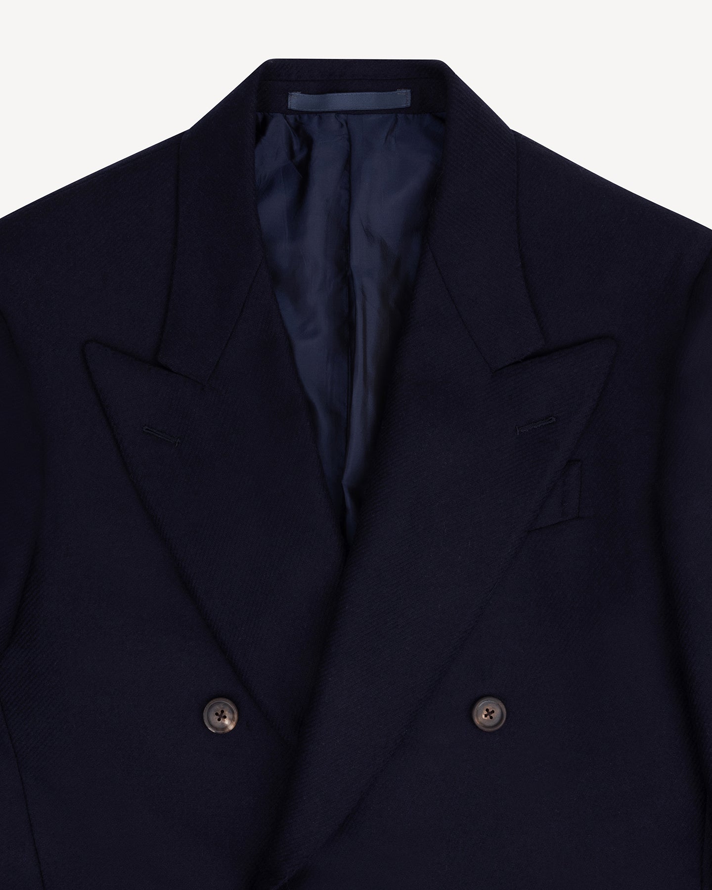 A navy flannel double breasted sport coat with peak lapels