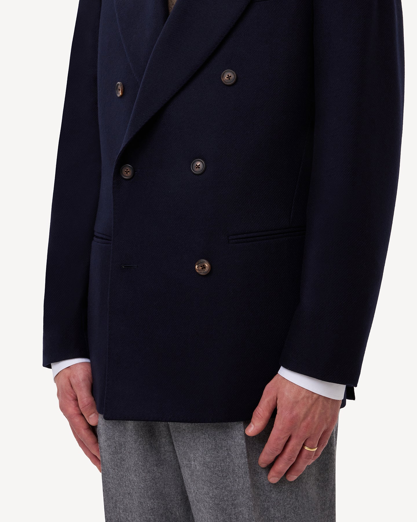 A navy flannel double breasted sport coat with jetted pockets