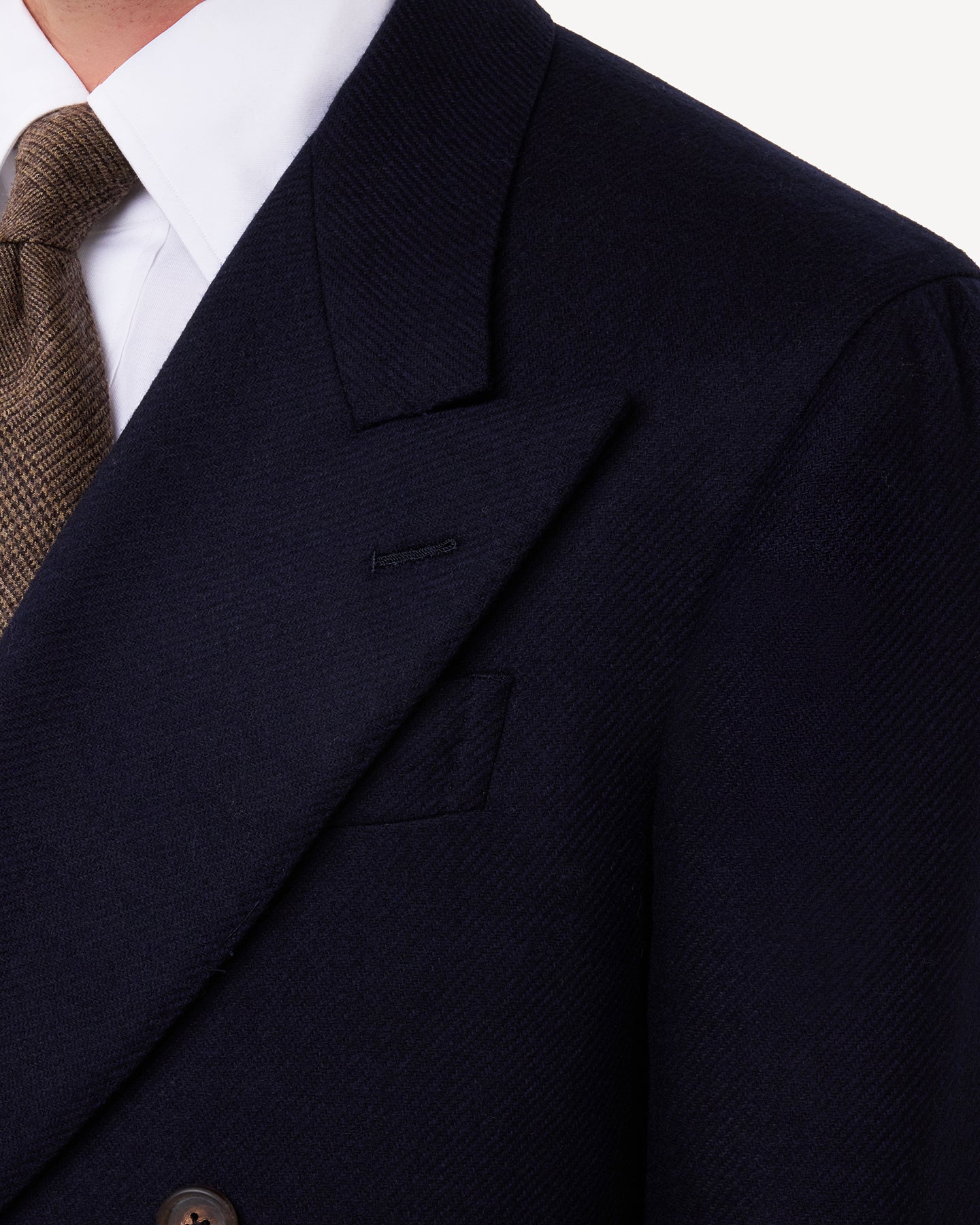 A navy double breasted blazer with peak lapels