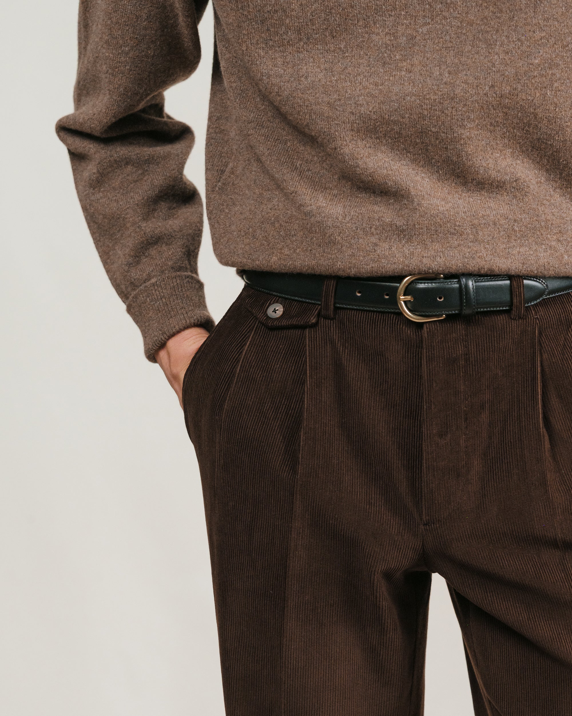 Brown sweater and dark brown corduroy pants with a black dress belt with brass buckle