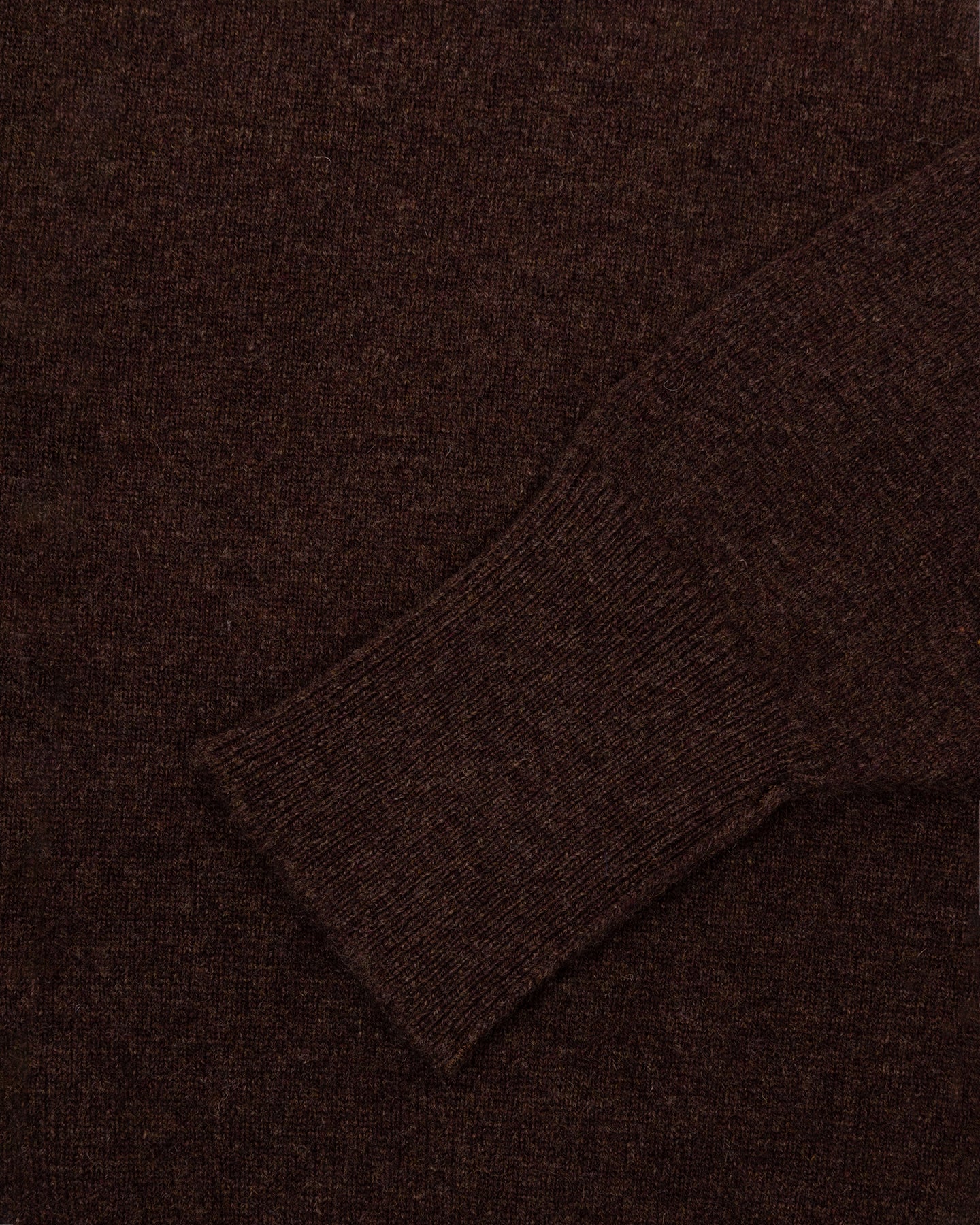 A dark brown lambswool sweater with turnback cuffs