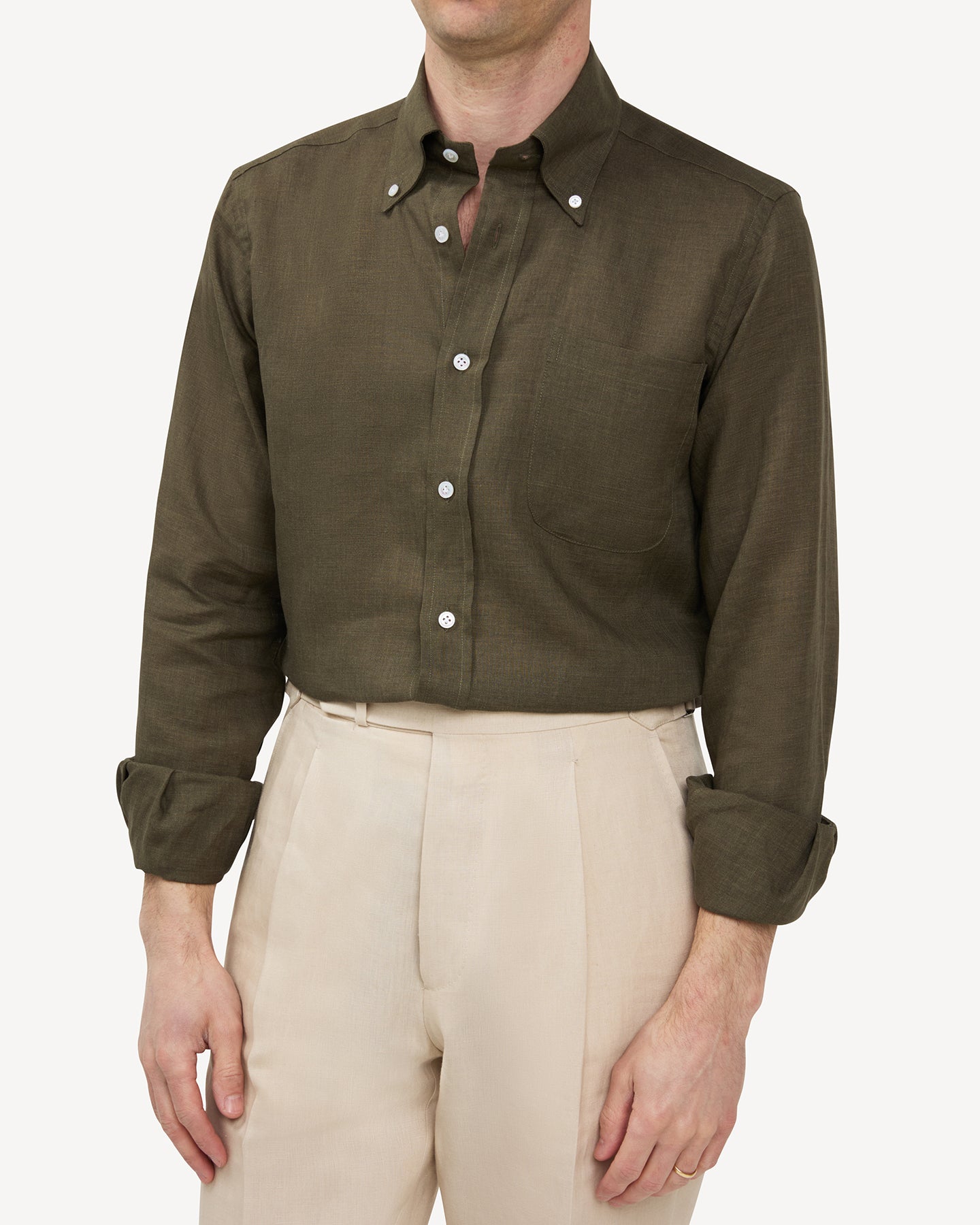 Man wearing olive green linen shirt and stone linen trousers