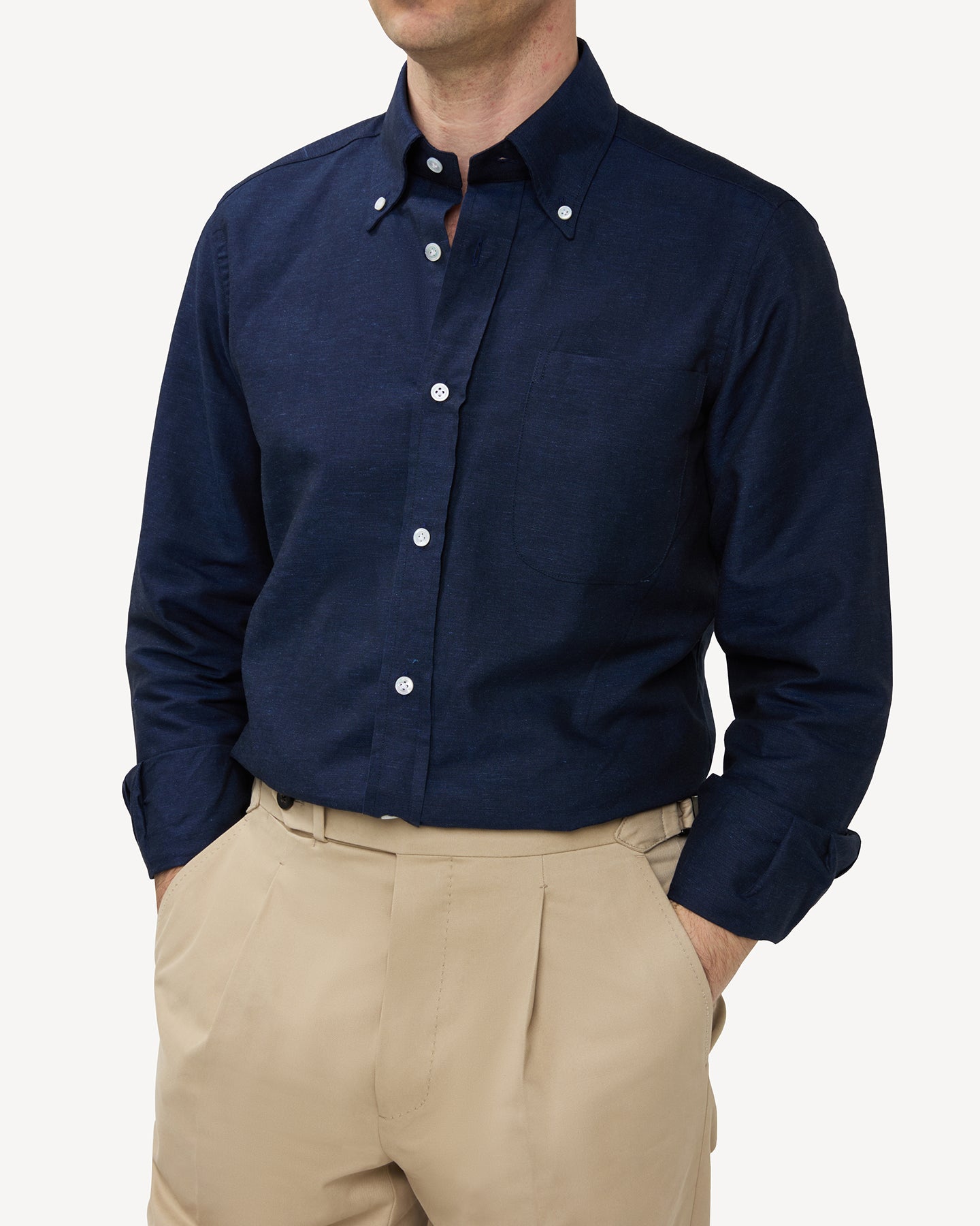 Man wearing a navy summer OCBD shirt with stone cotton trousers