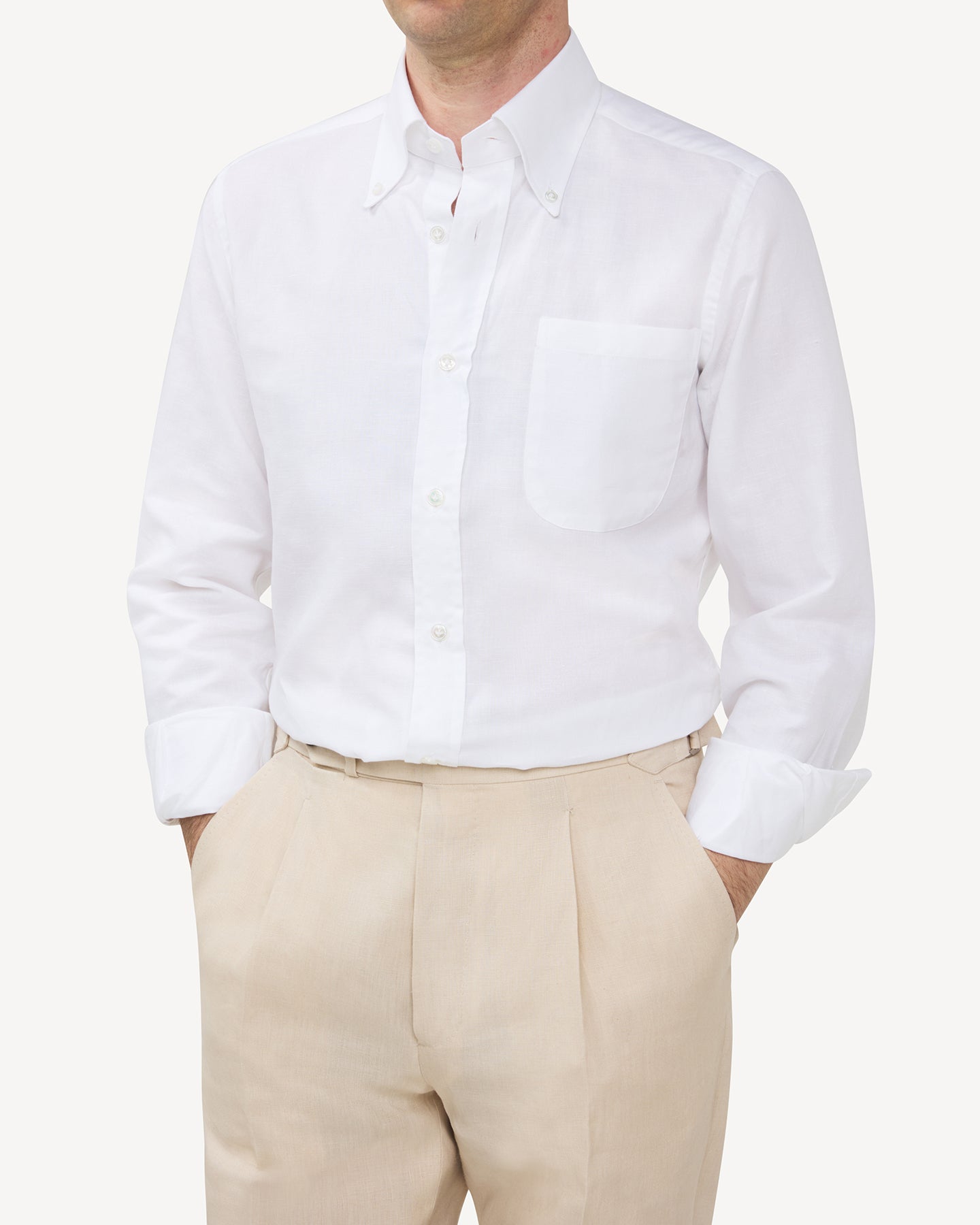 Man wearing a white summer OCBD shirt with stone linen trousers
