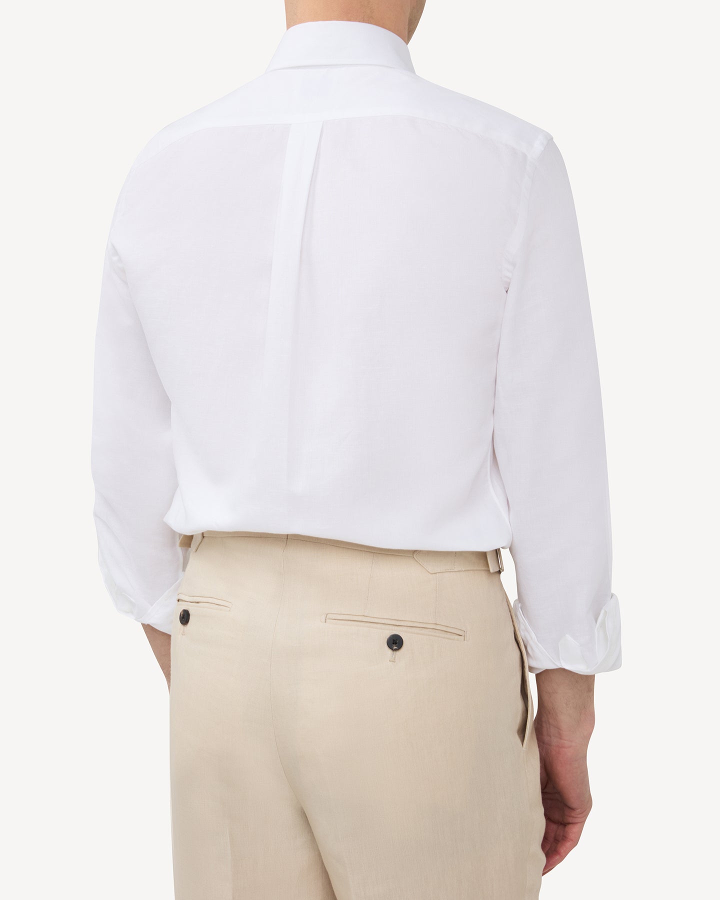 Man wearing a white summer OCBD shirt with stone linen trousers
