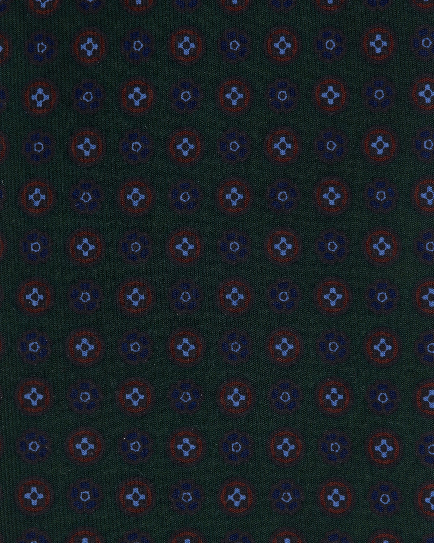 Dark green Ancient Madder tie with small floral pattern in shades of light blue, dark blue, and brown.