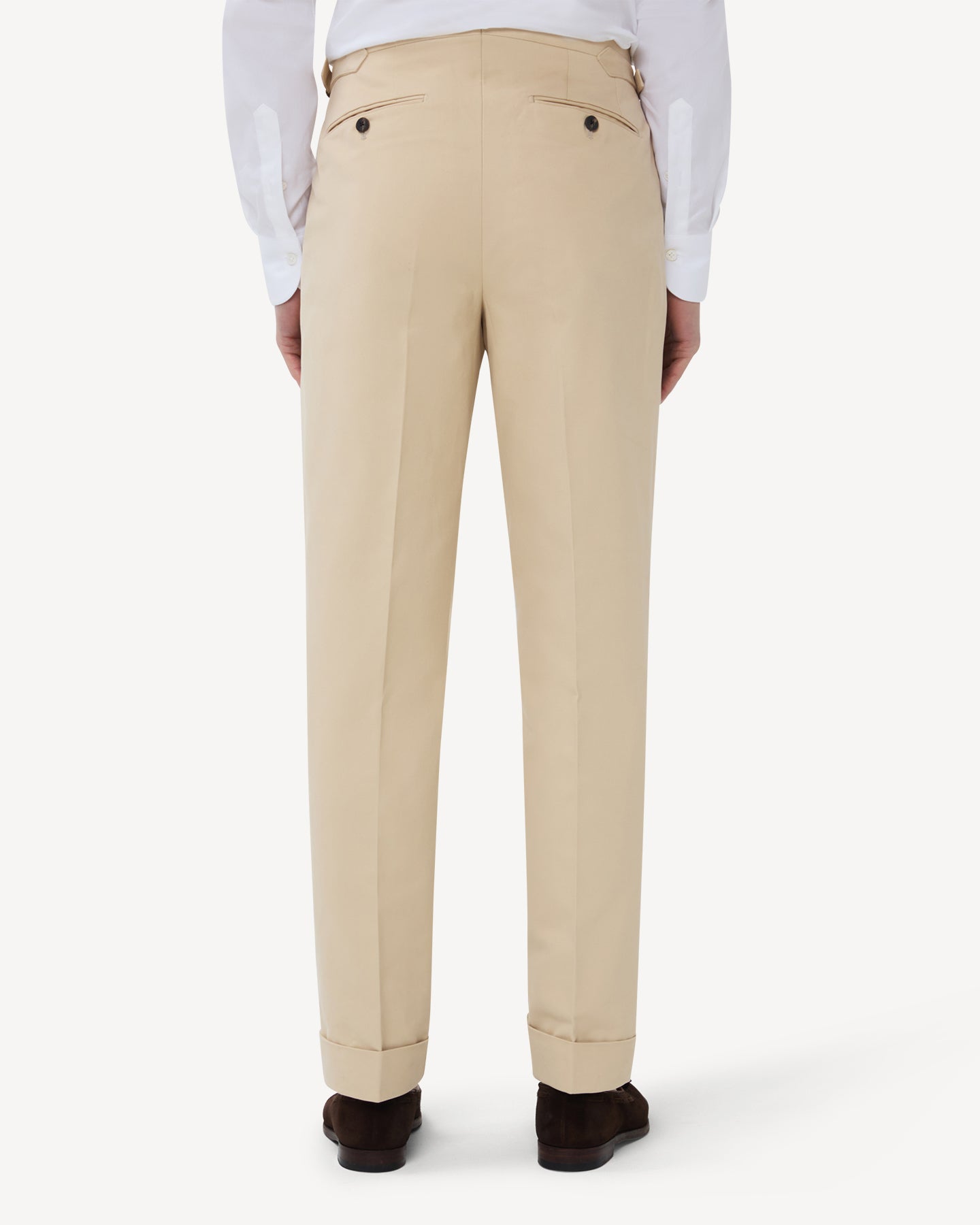 The back of cream cotton trousers with single pleats and side adjusters