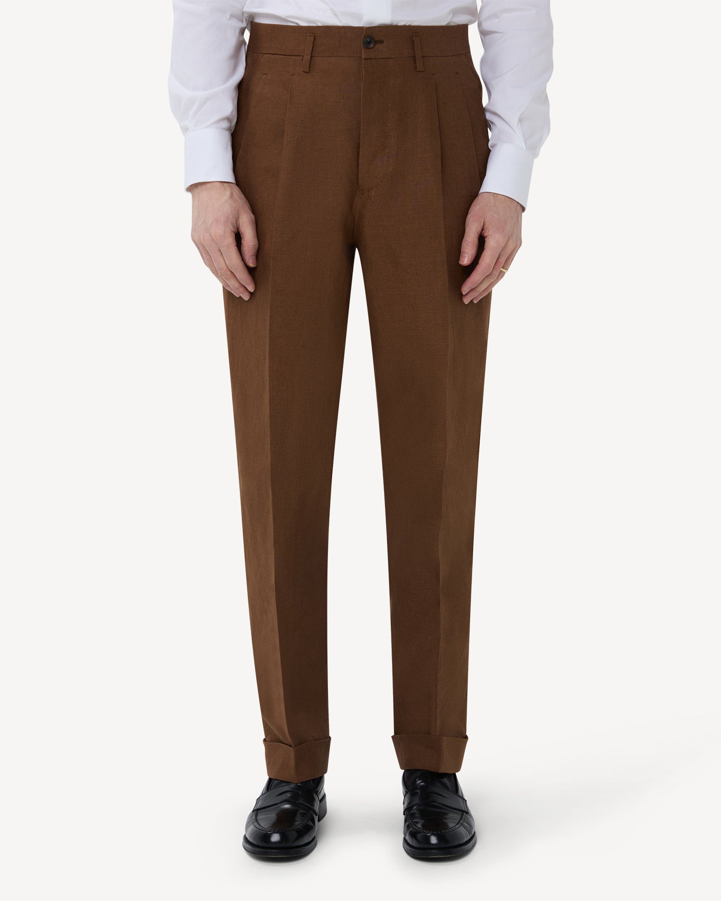 The front of dark tan linen trousers with double pleats and belt loops