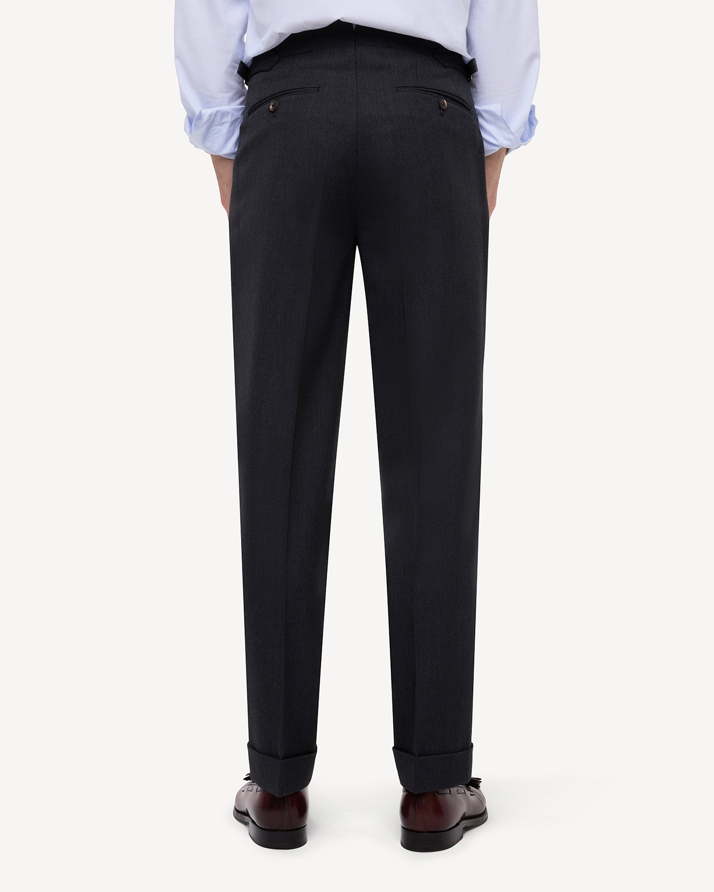 Back view of dark grey cavalry twill trousers with single pleats and side adjusters