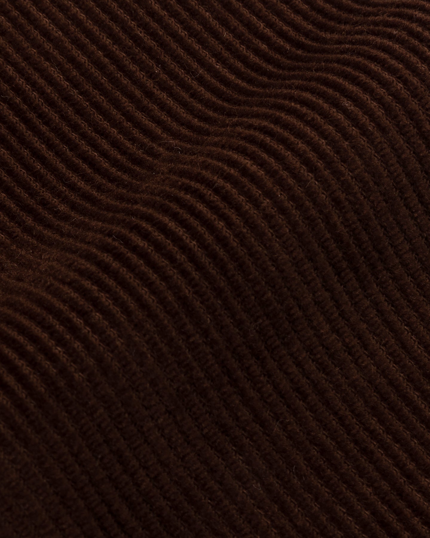 A close up of chocolate brown corduroy fabric