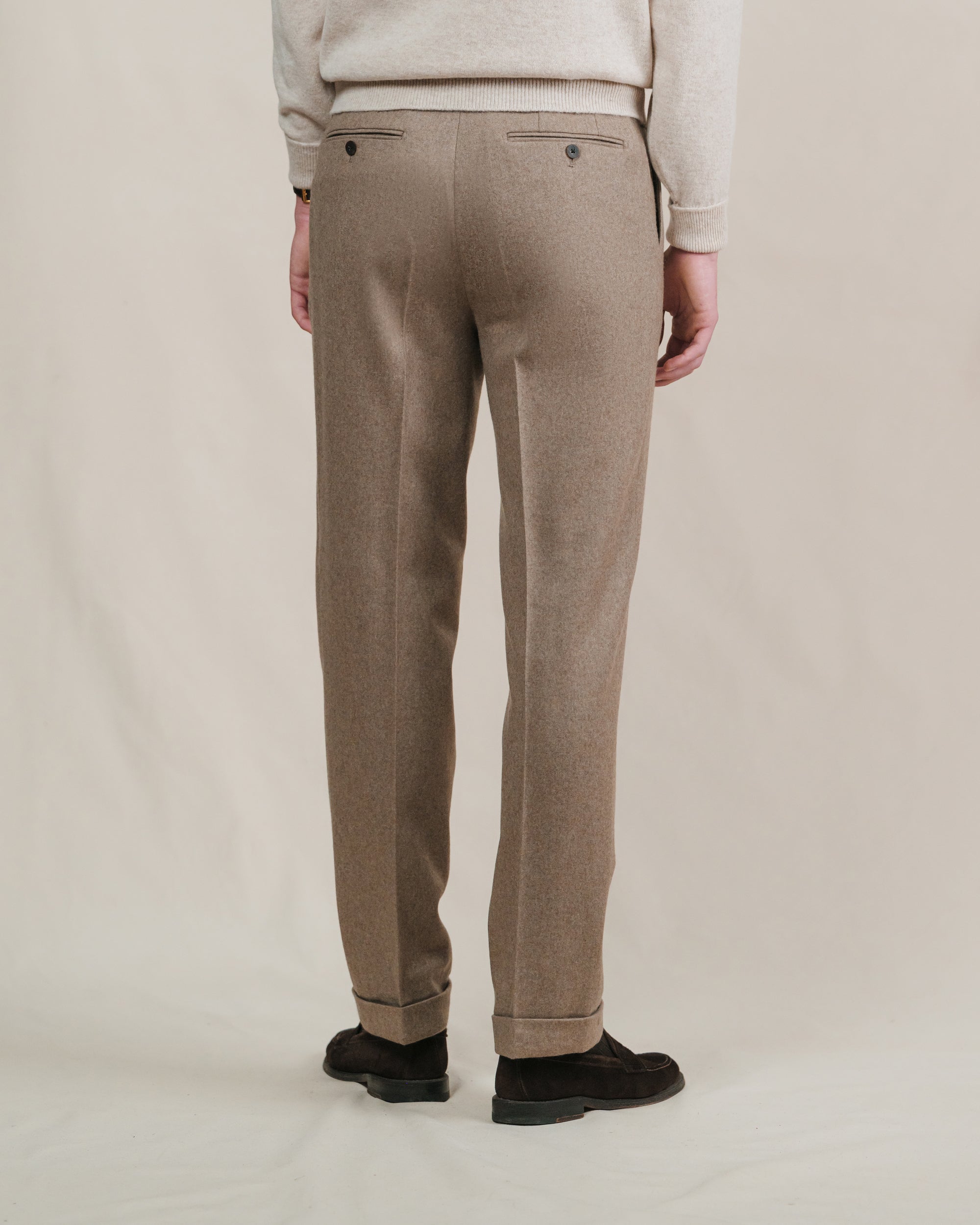 Man wearing fawn flannel trousers with brown suede penny loafers