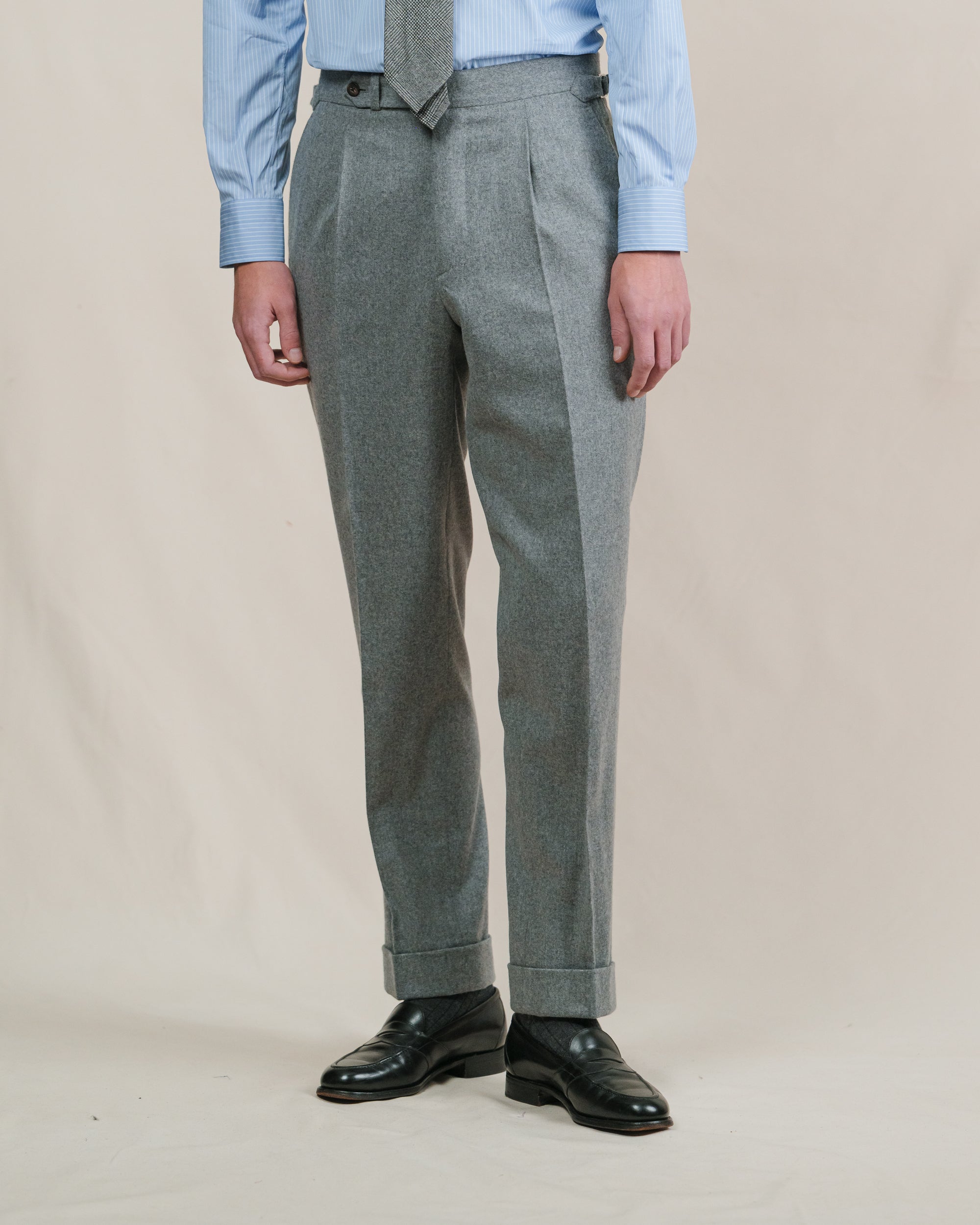 Man wearing a pair of light grey flannel trousers