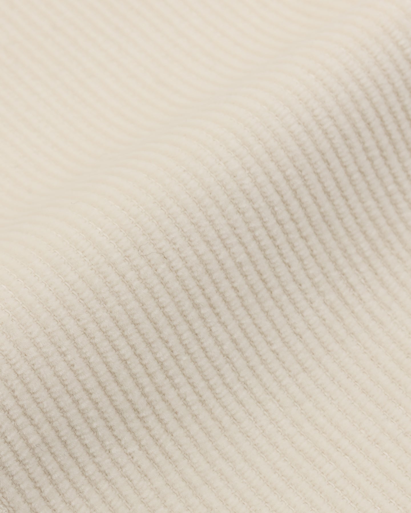 A close up of cream corduroy fabric