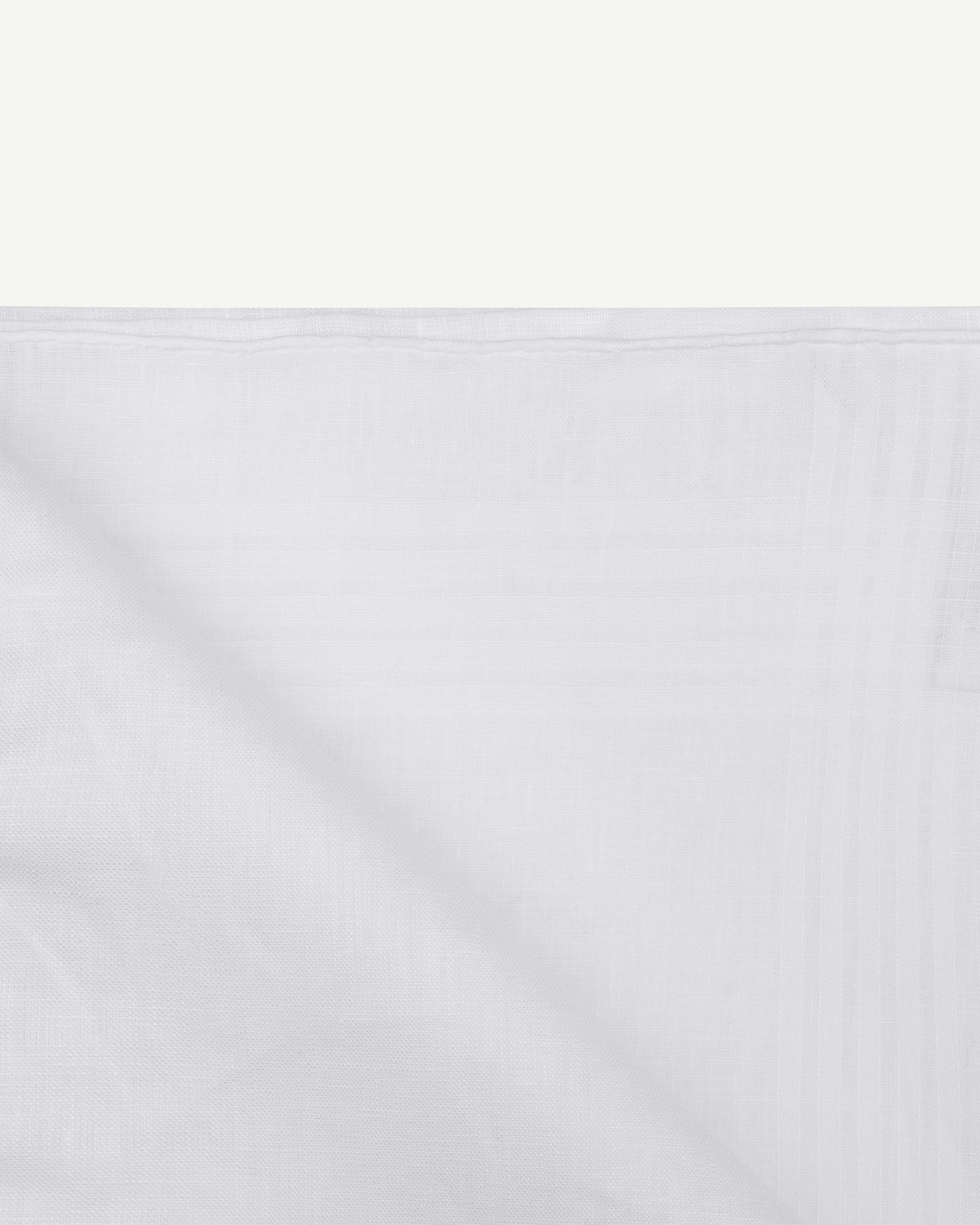 White linen handkerchief with corded texture and hand-rolled edges