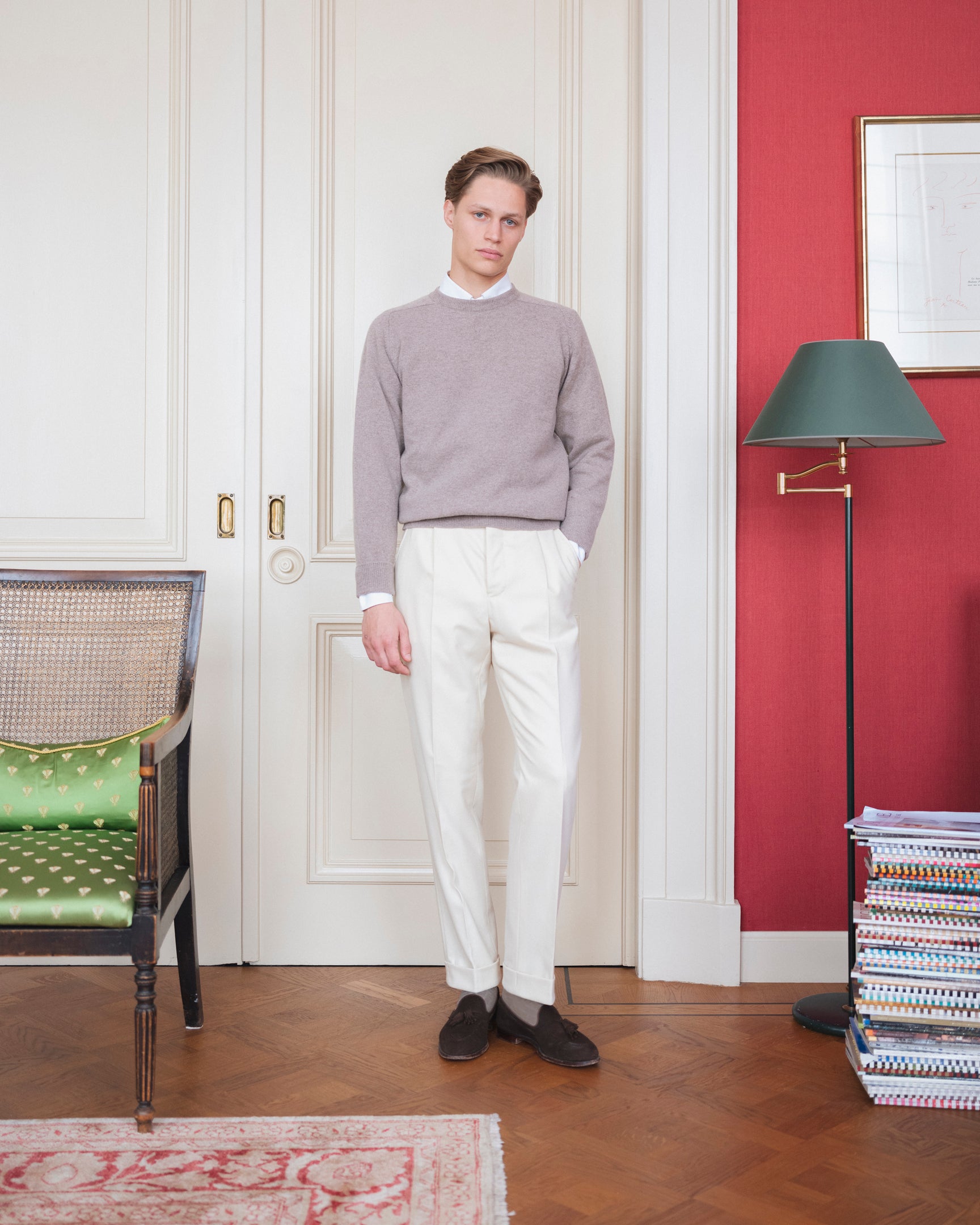 Man wearing cream Fox Brothers cricket flannel trousers and a light grey crewneck sweater