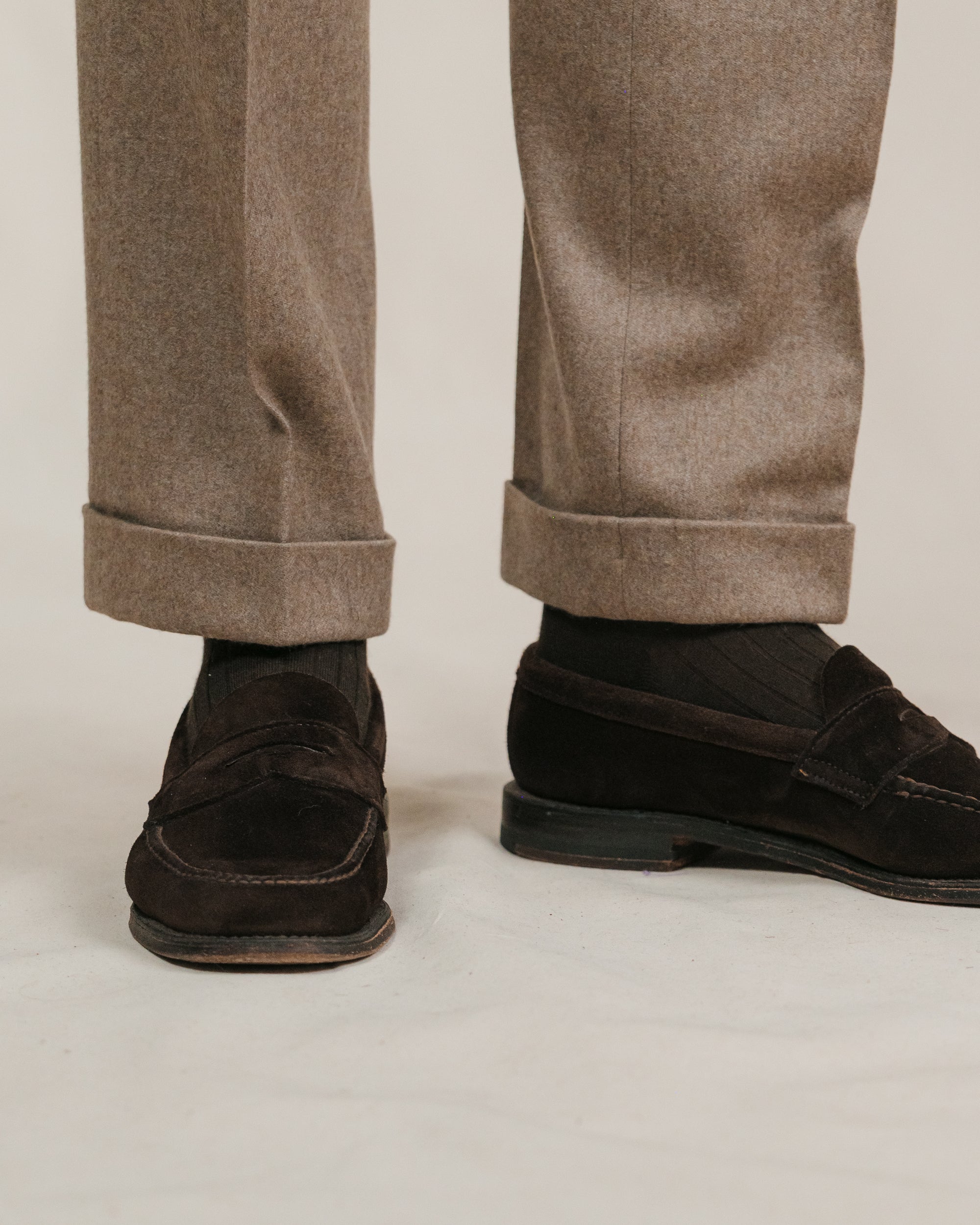 Fawn flannel trousers with cuffs with brown socks and brown suede penny loafers