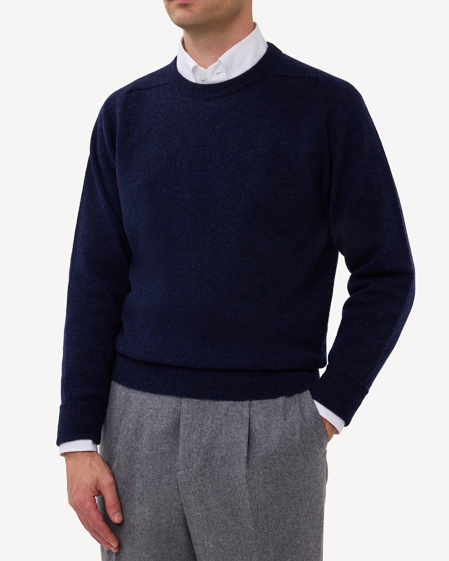 Man wearing a dark blue lambswool crew neck sweater