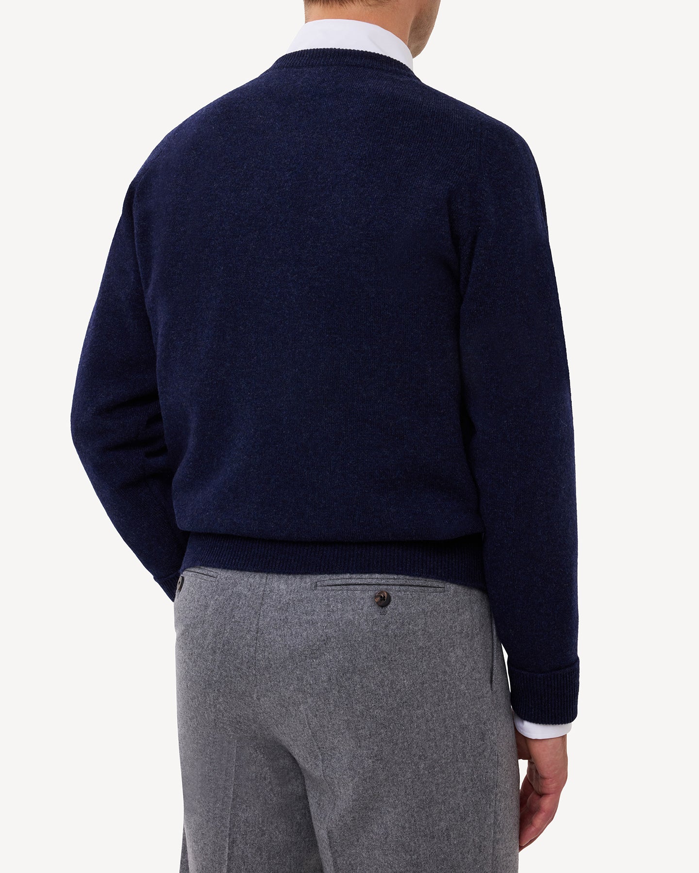 Man wearing a dark blue lambswool crew neck sweater