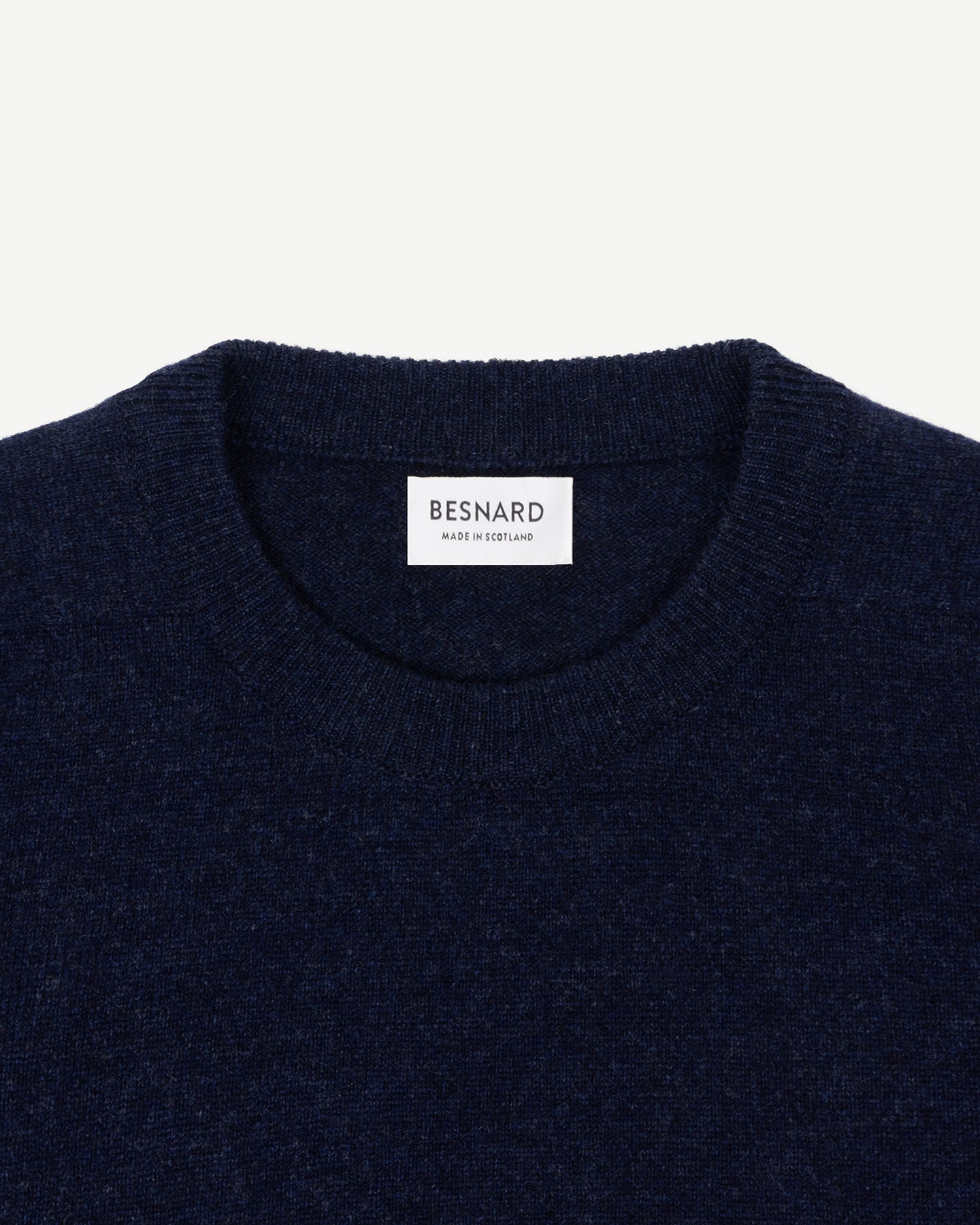 A dark blue lambswool crew neck sweater