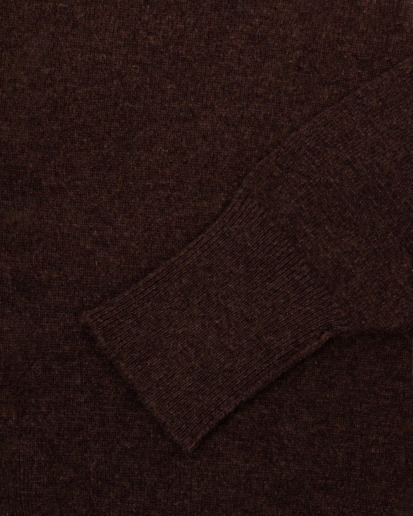 A dark brown lambswool sweater with turnback cuffs