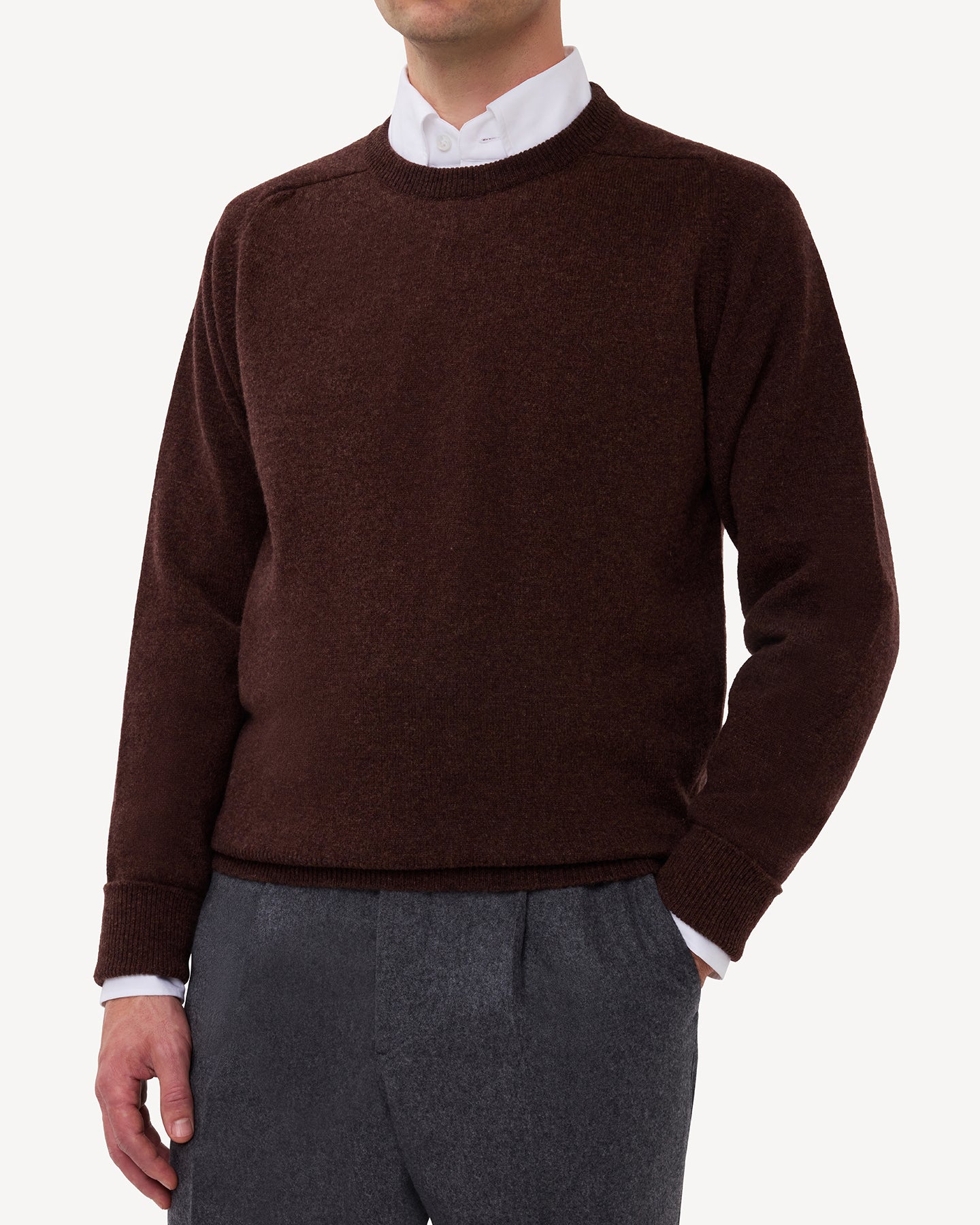 Man wearing a dark brown lambswool crew neck sweater