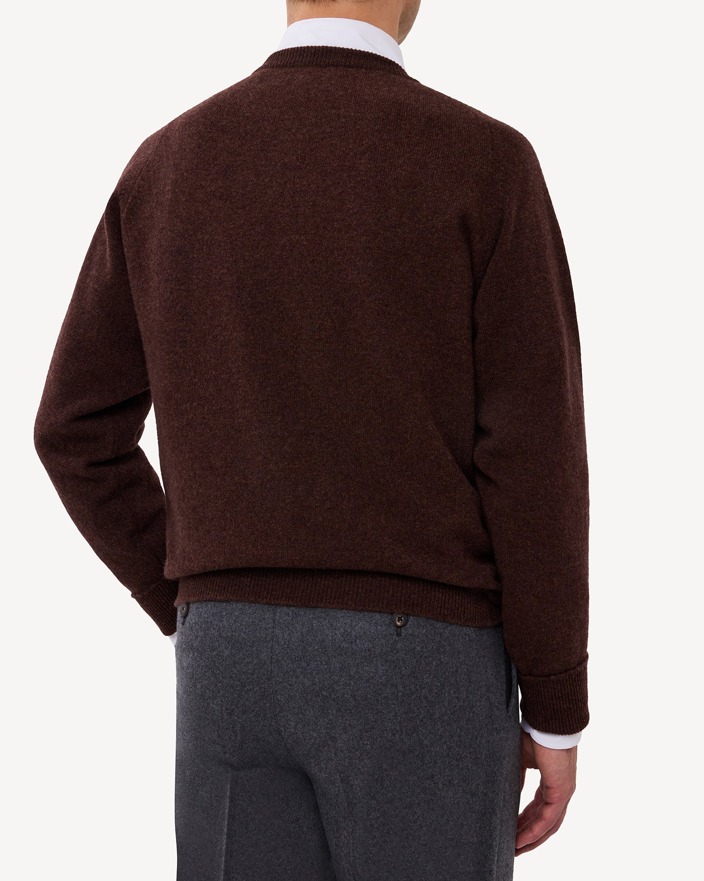 Man wearing a dark brown lambswool crew neck sweater