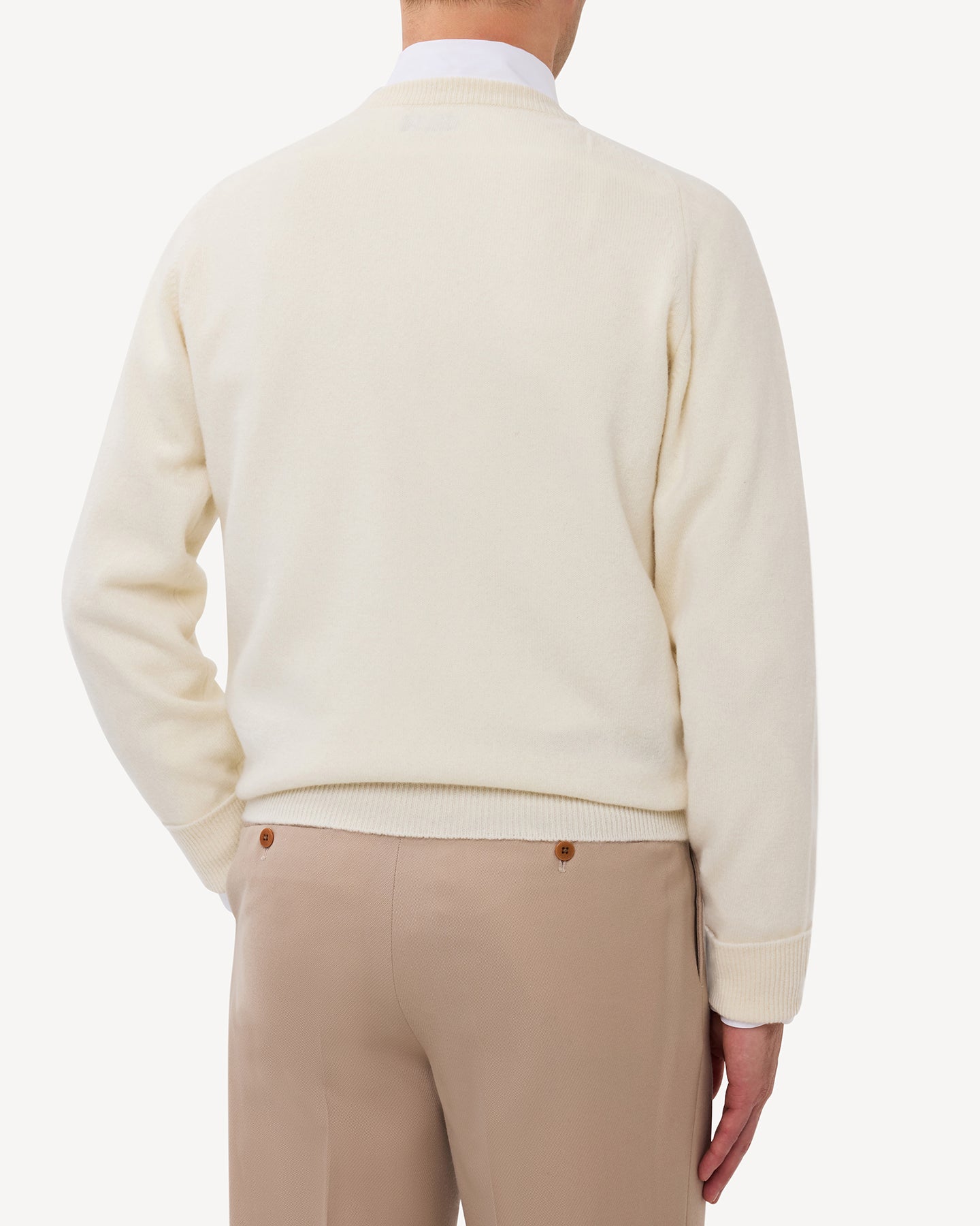 Man wearing an ecru lambswool crew neck sweater