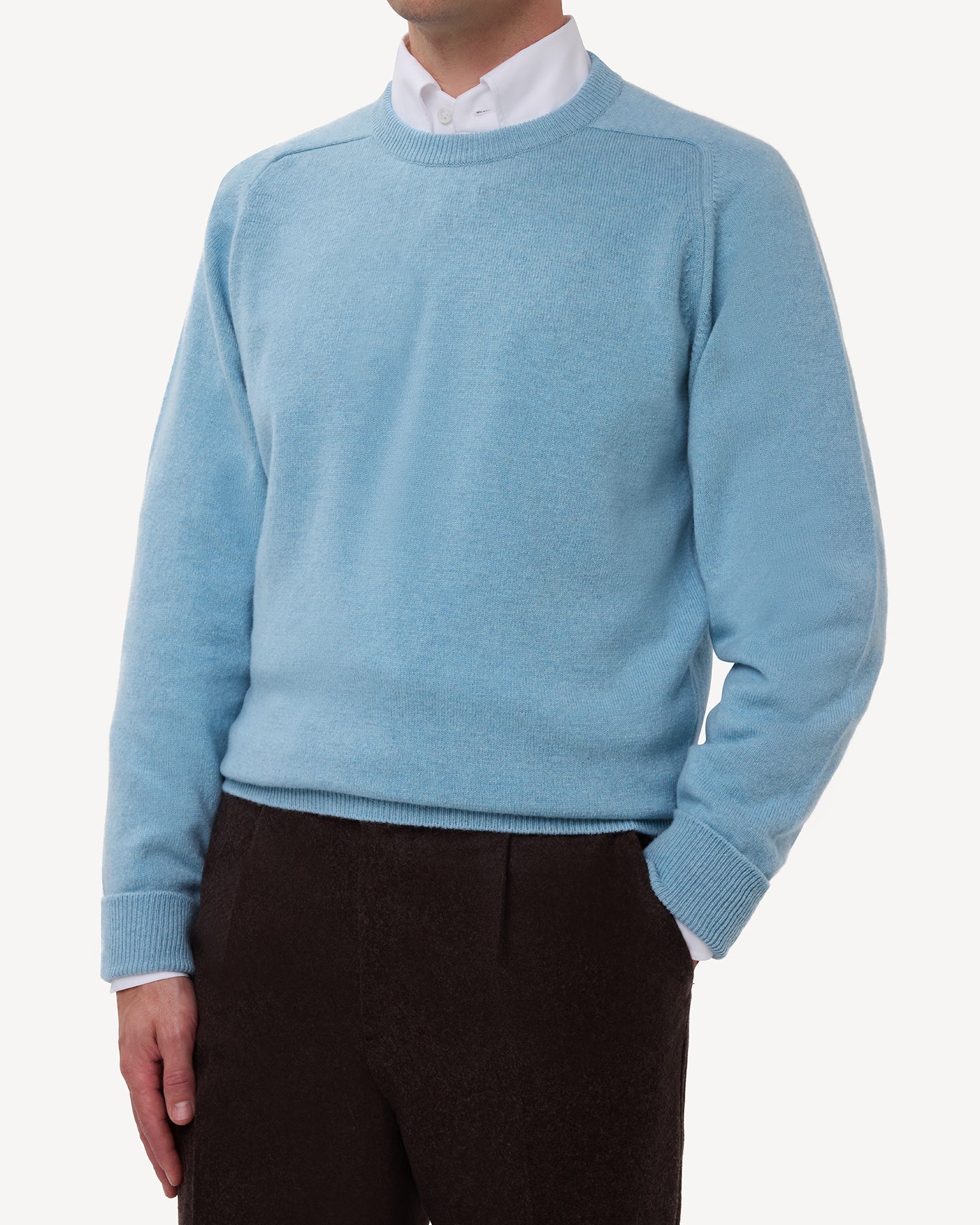 Man wearing a light blue lambswool crew neck sweater