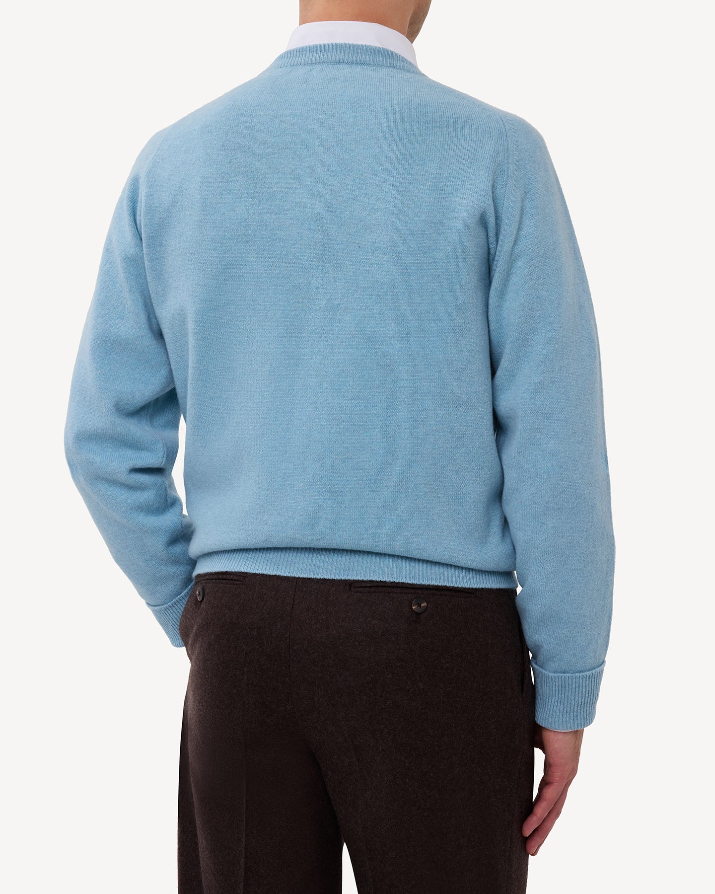 Man wearing a light blue lambswool crew neck sweater