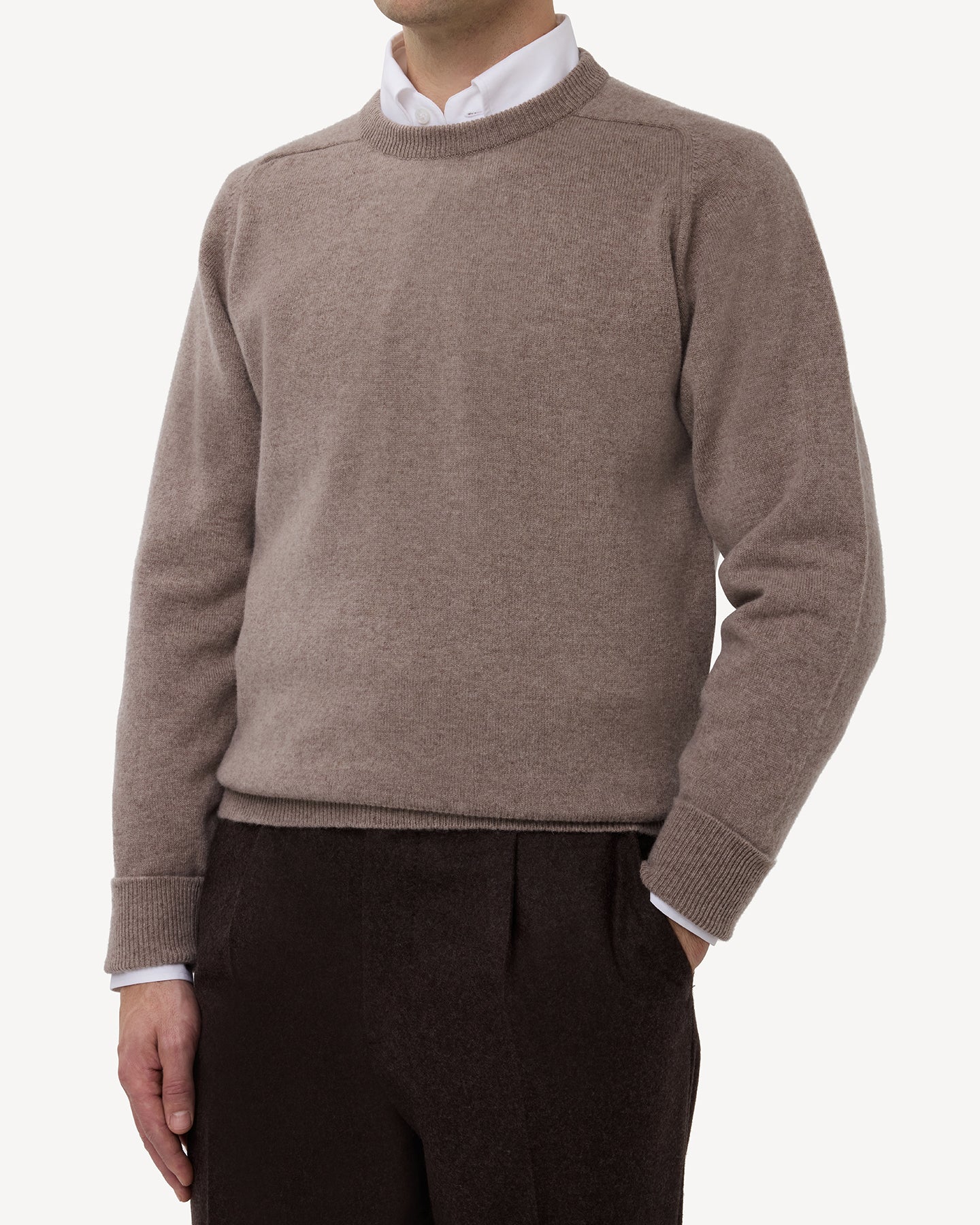 Man wearing a light brown lambswool crew neck sweater