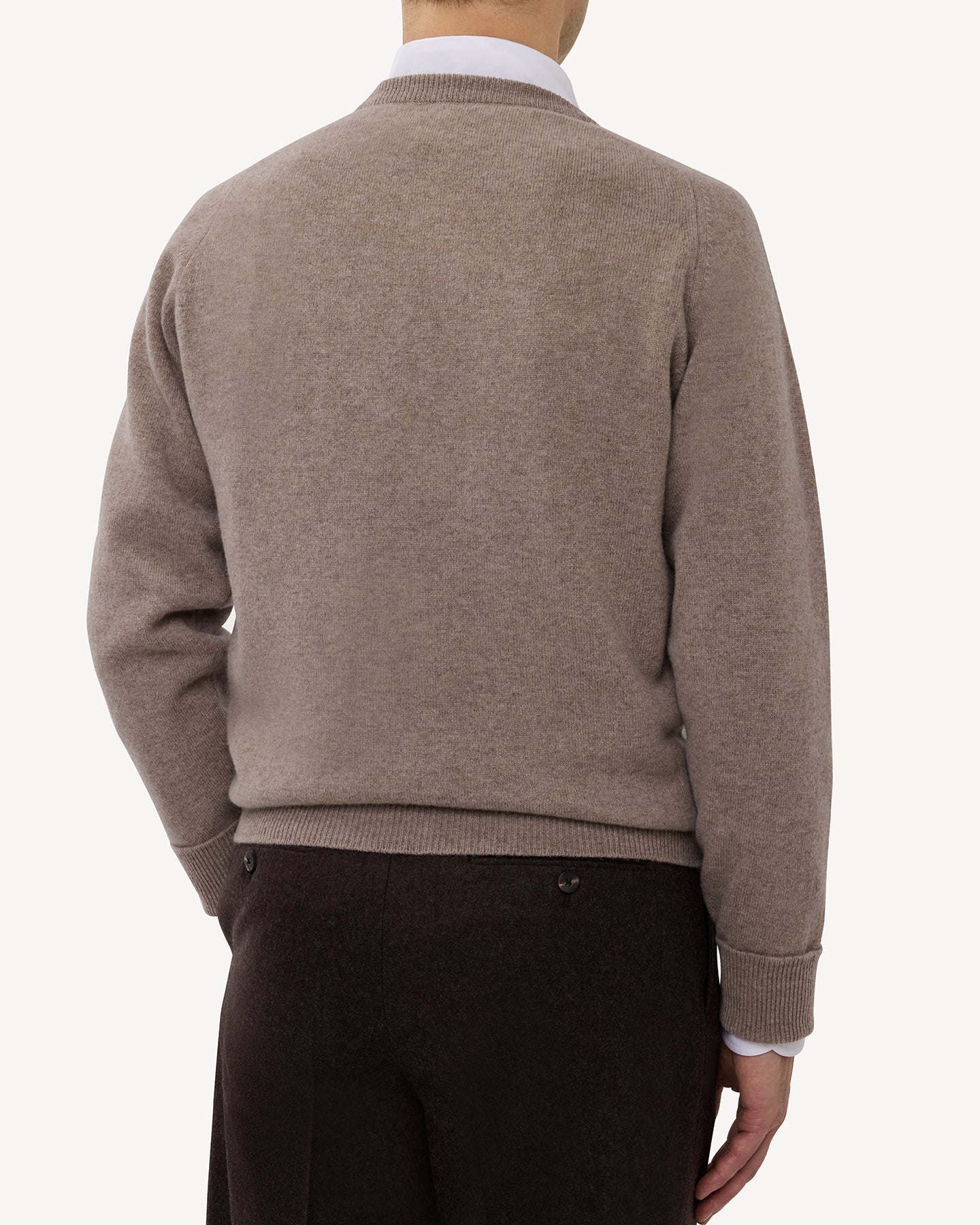 Man wearing a light brown lambswool crew neck sweater