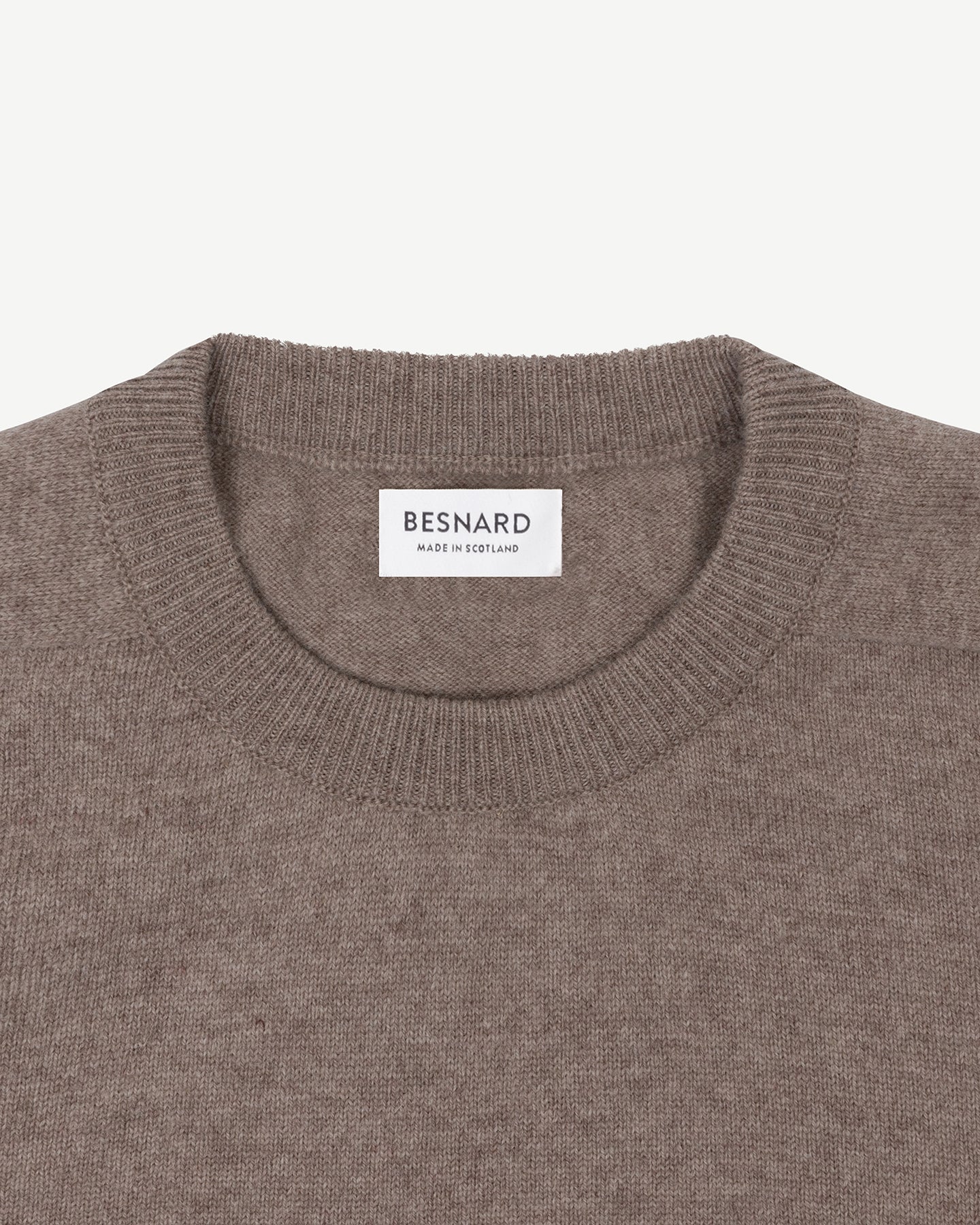 A light brown lambswool crew neck sweater