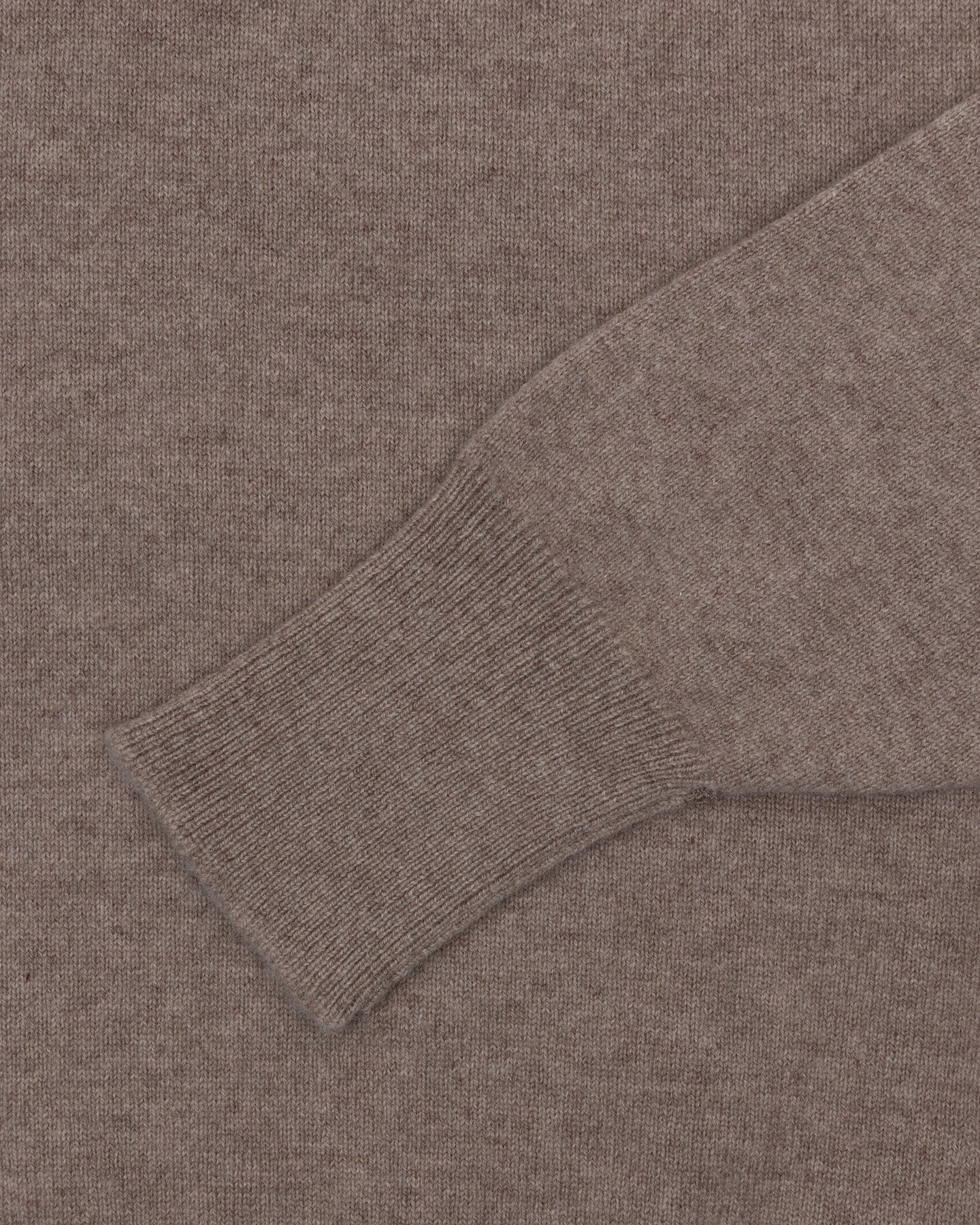 A light brown lambswool sweater with turnback cuffs