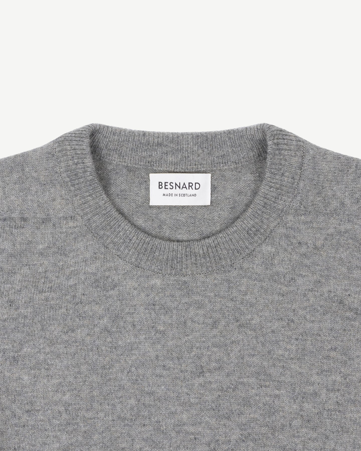 A light grey lambswool crew neck sweater