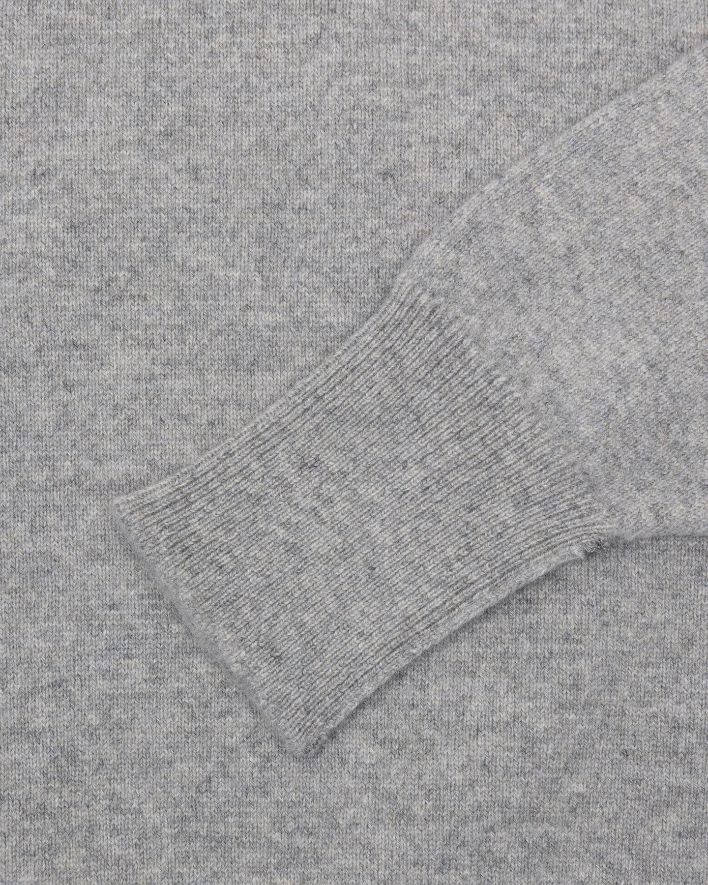 A light grey lambswool sweater with turnback cuffs