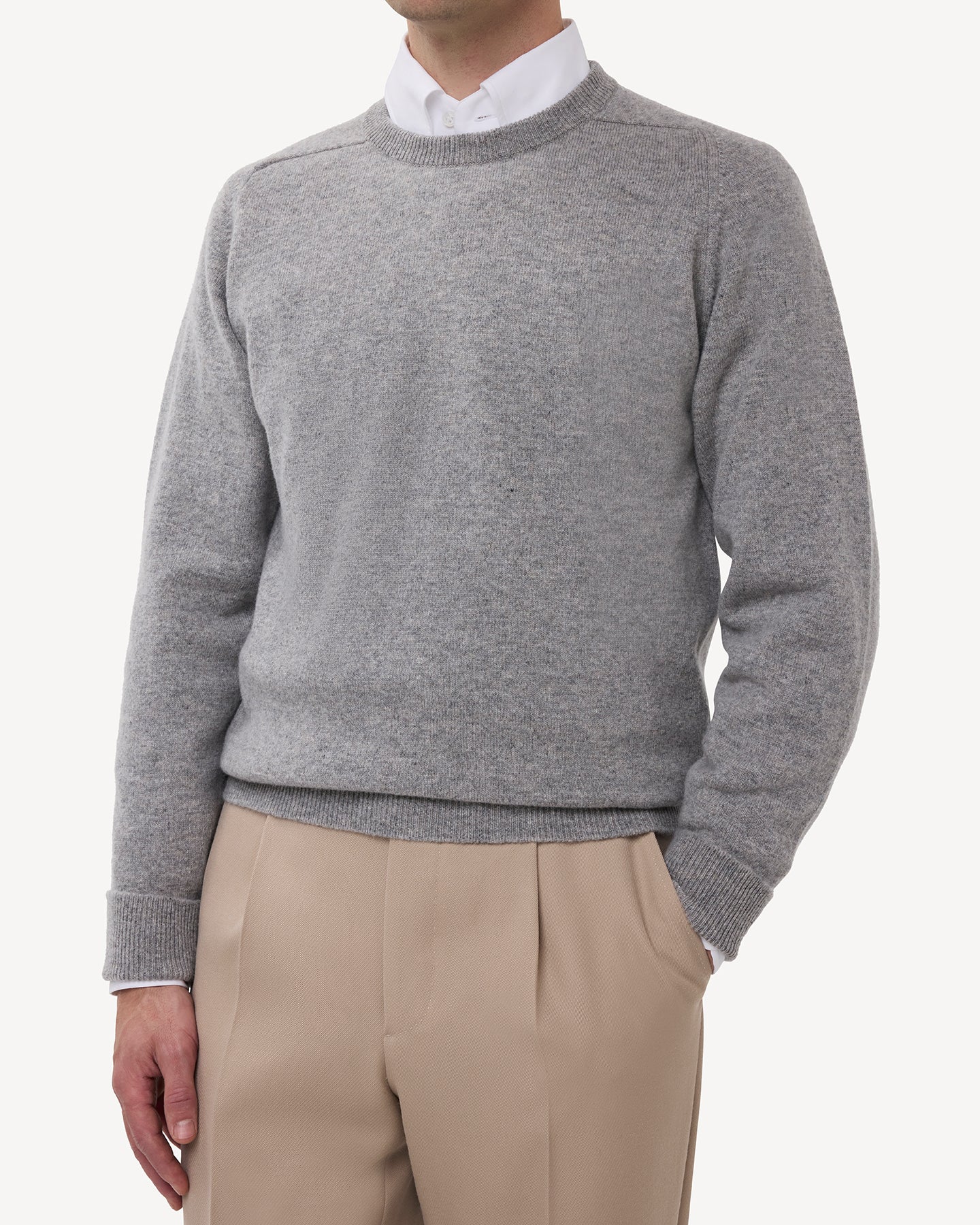 Man wearing a light grey lambswool crew neck sweater