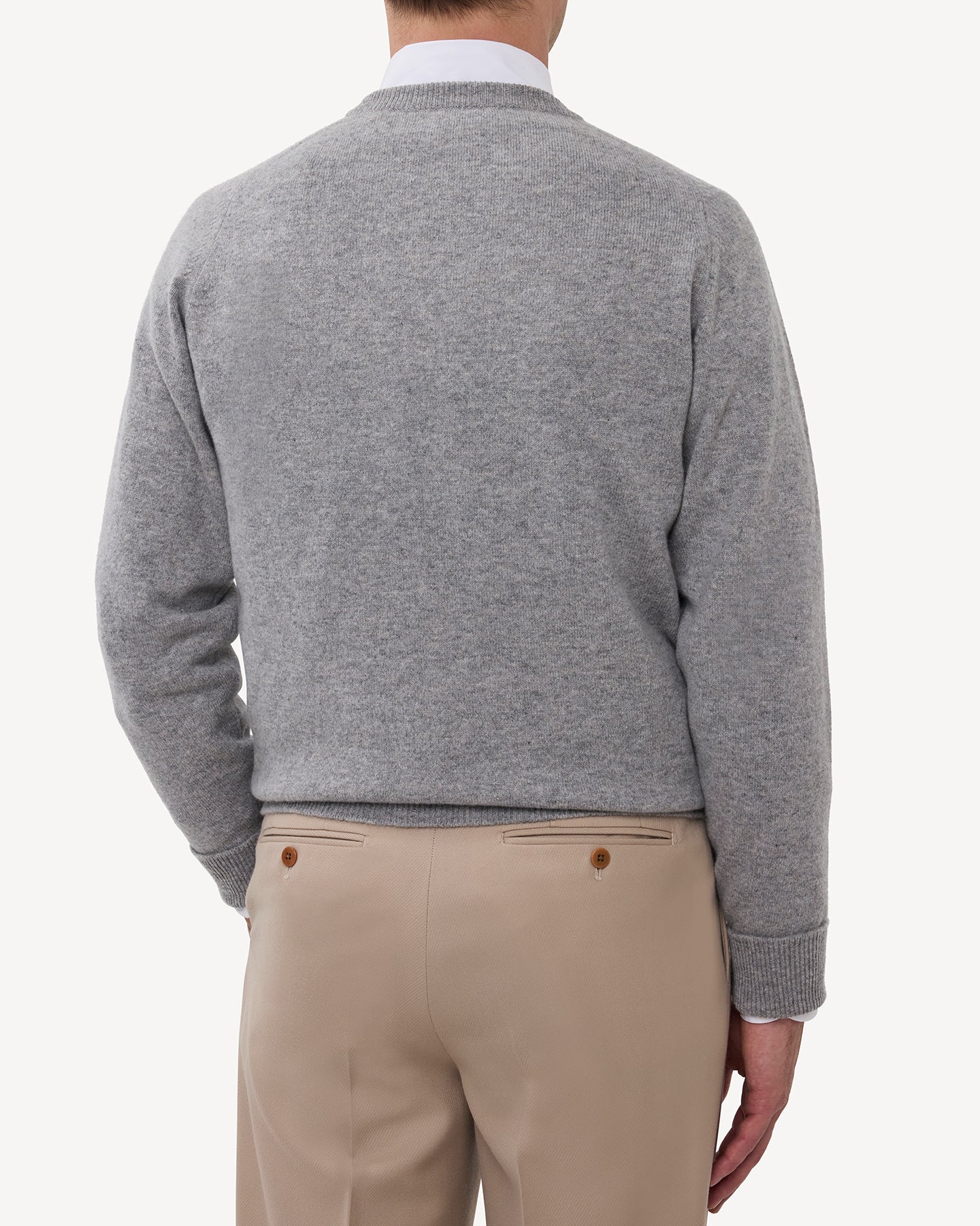 Man wearing a light grey lambswool crew neck sweater