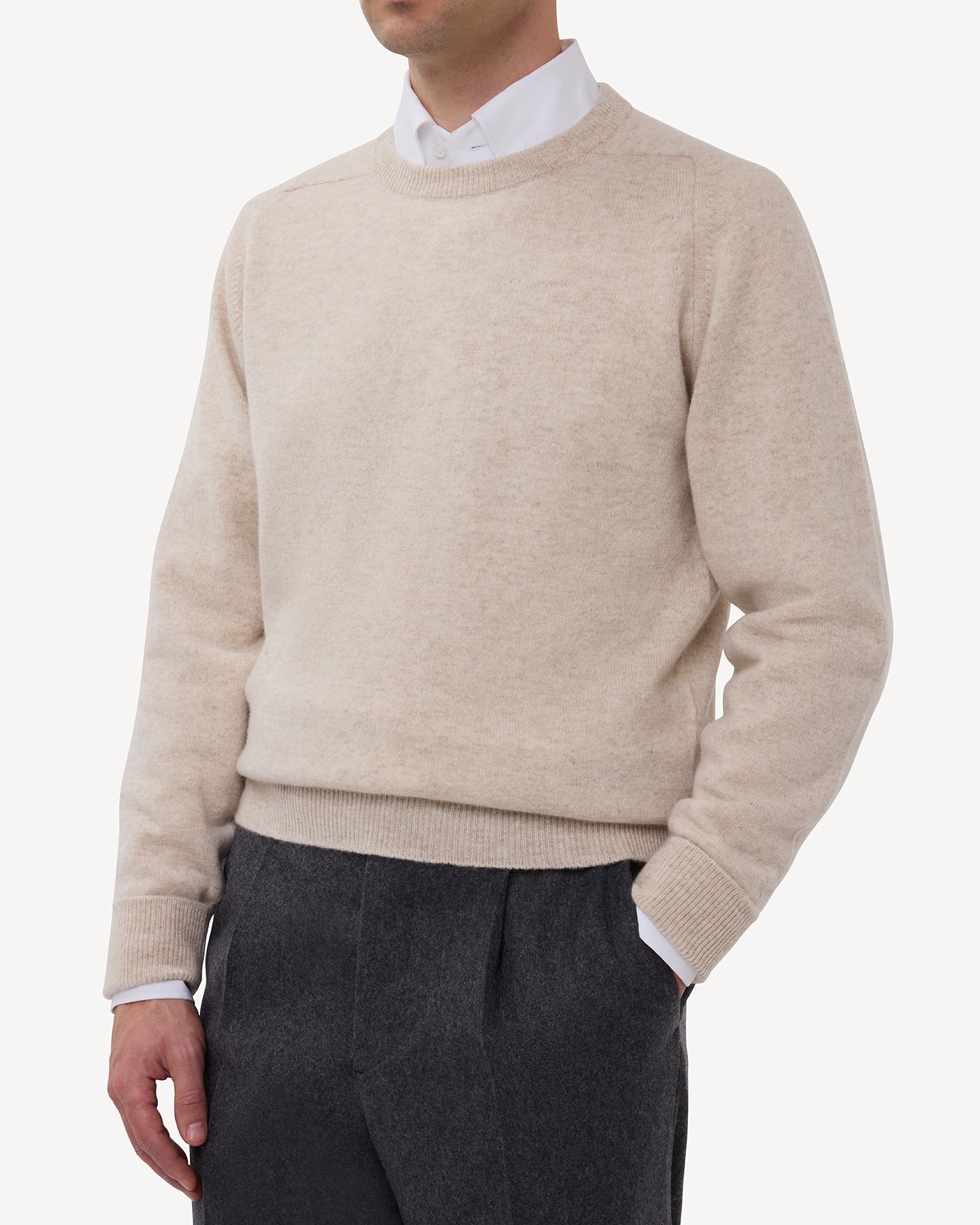 Man wearing an oatmeal lambswool crew neck sweater