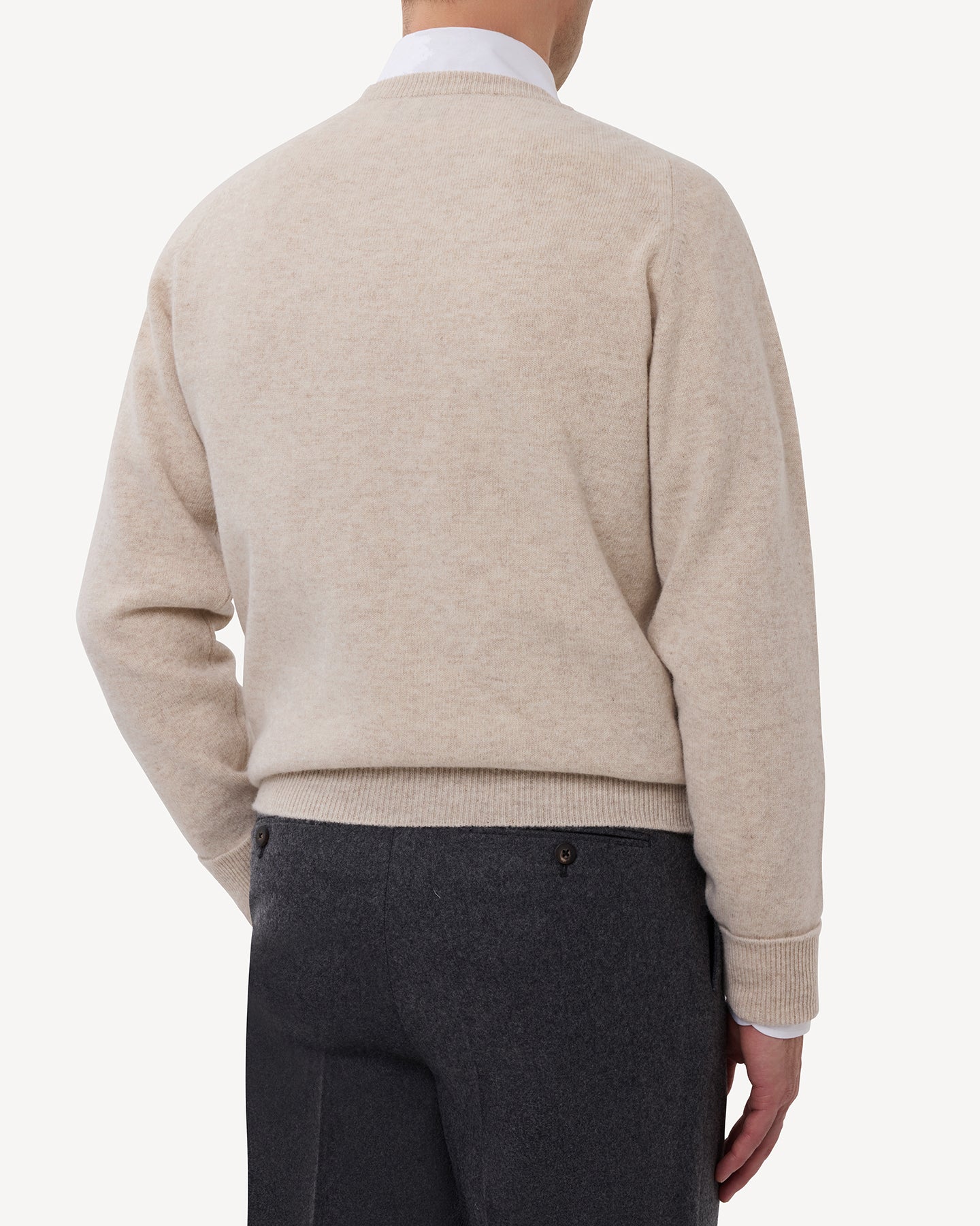 Man wearing an oatmeal lambswool crew neck sweater