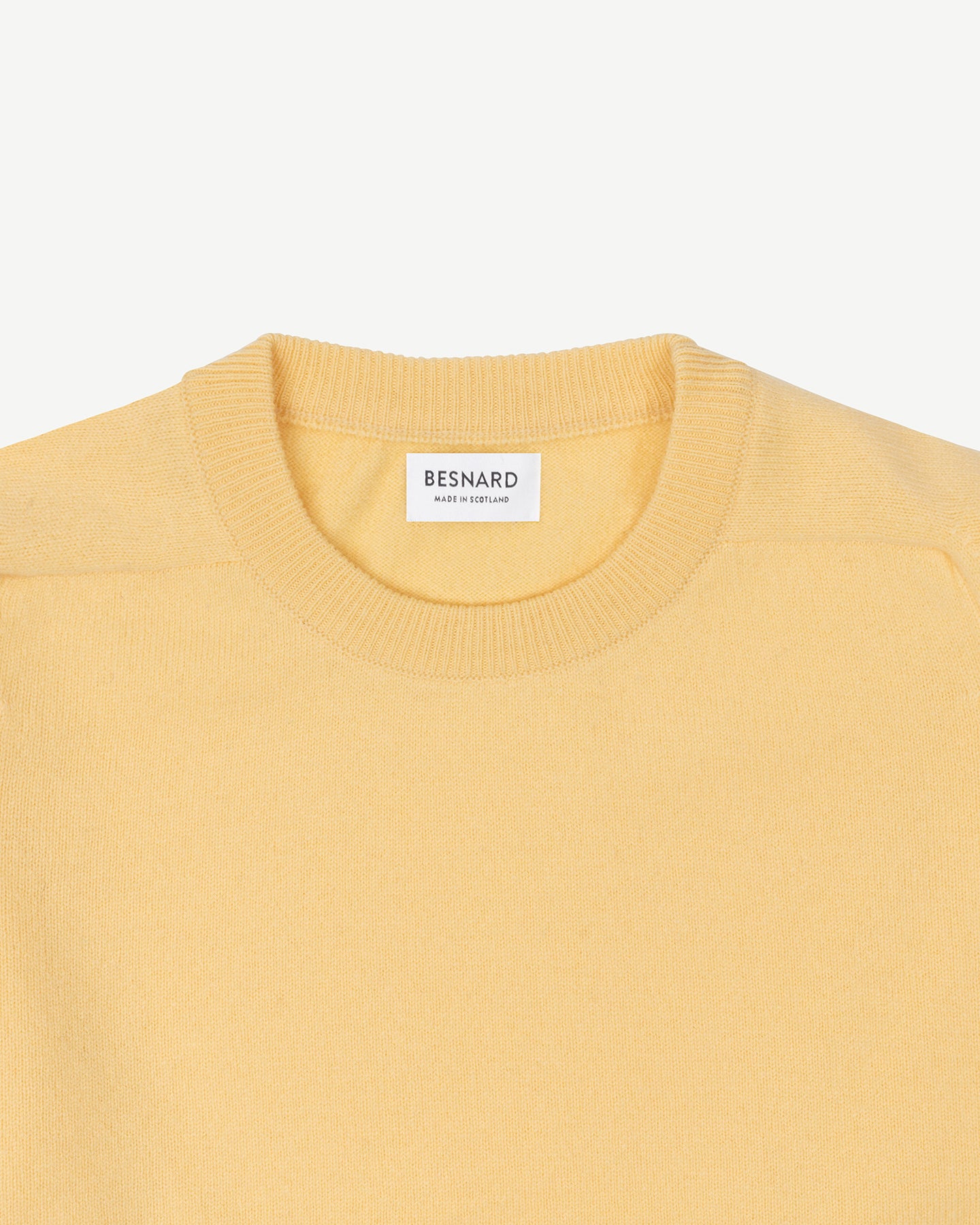 A yellow lambswool crew neck sweater