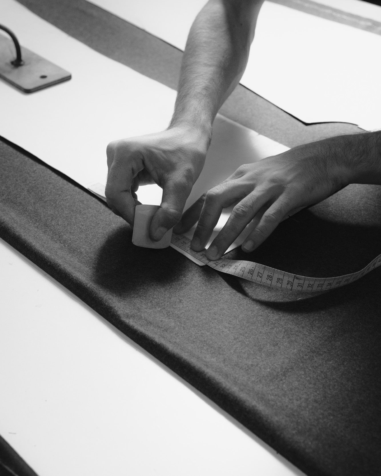 Chalking the patterns before cutting trousers