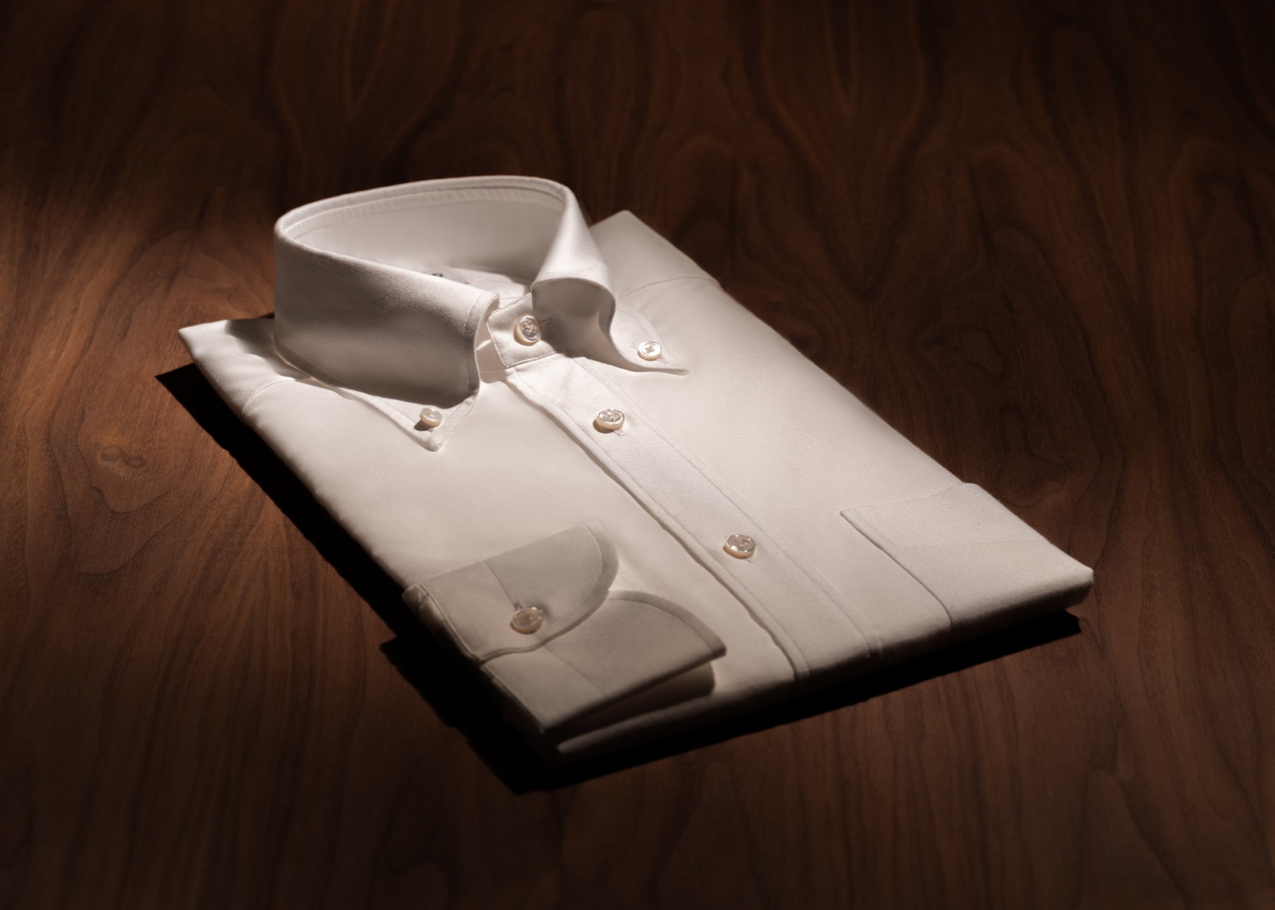 White OCBD shirt on a wooden table