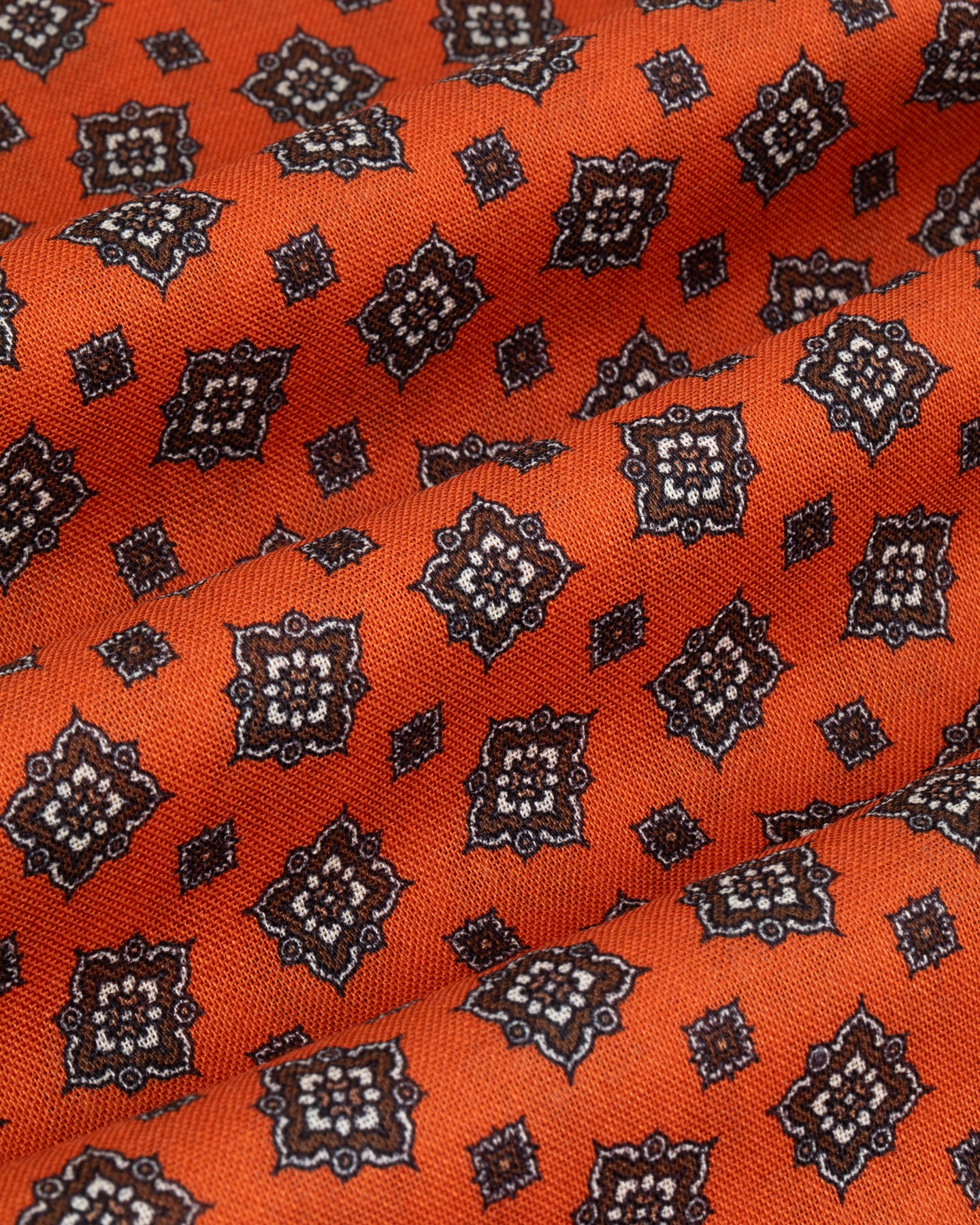 Zoom of orange wool silk fabric with medallion print