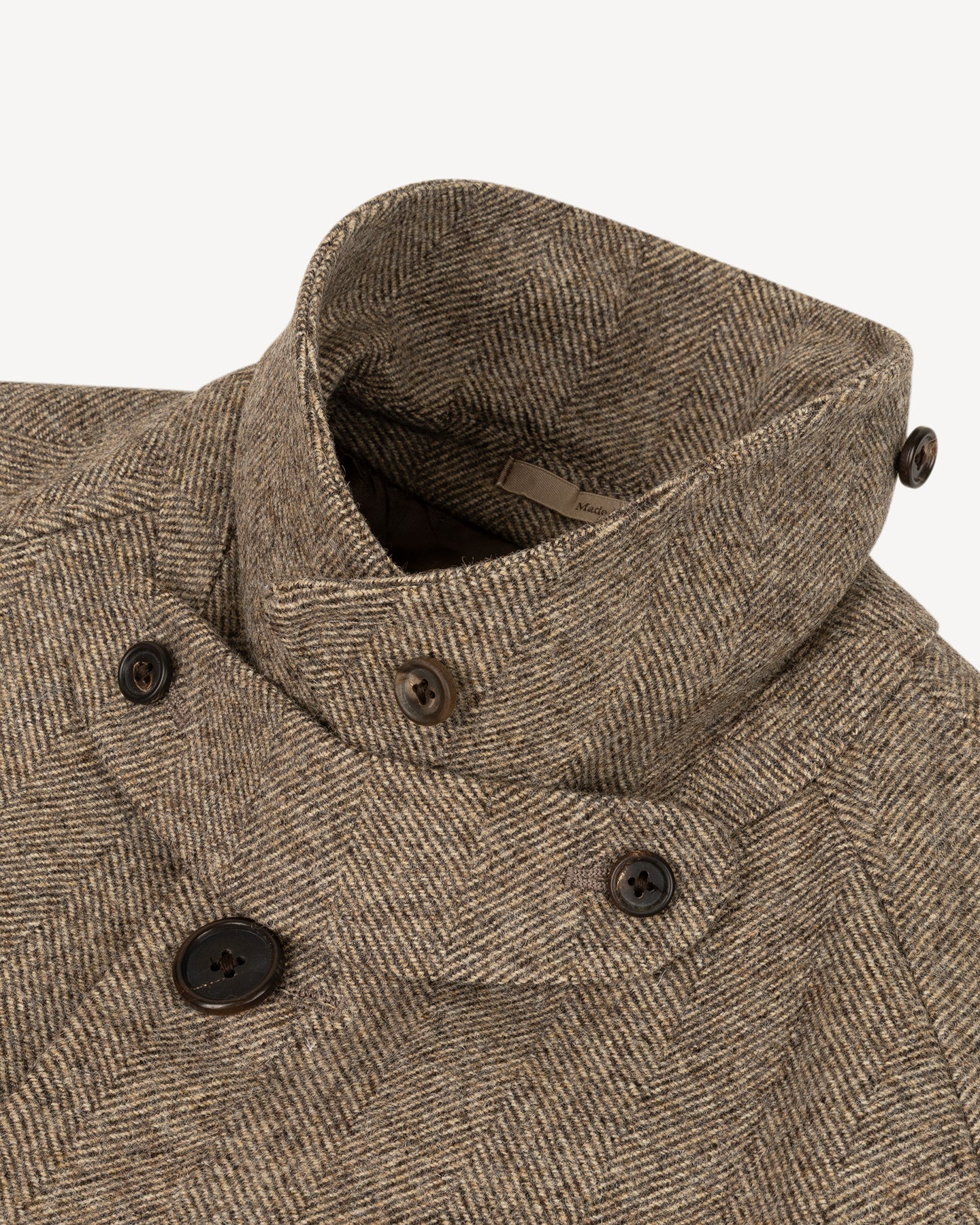 Light brown herringbone tweed coat with throat latch
