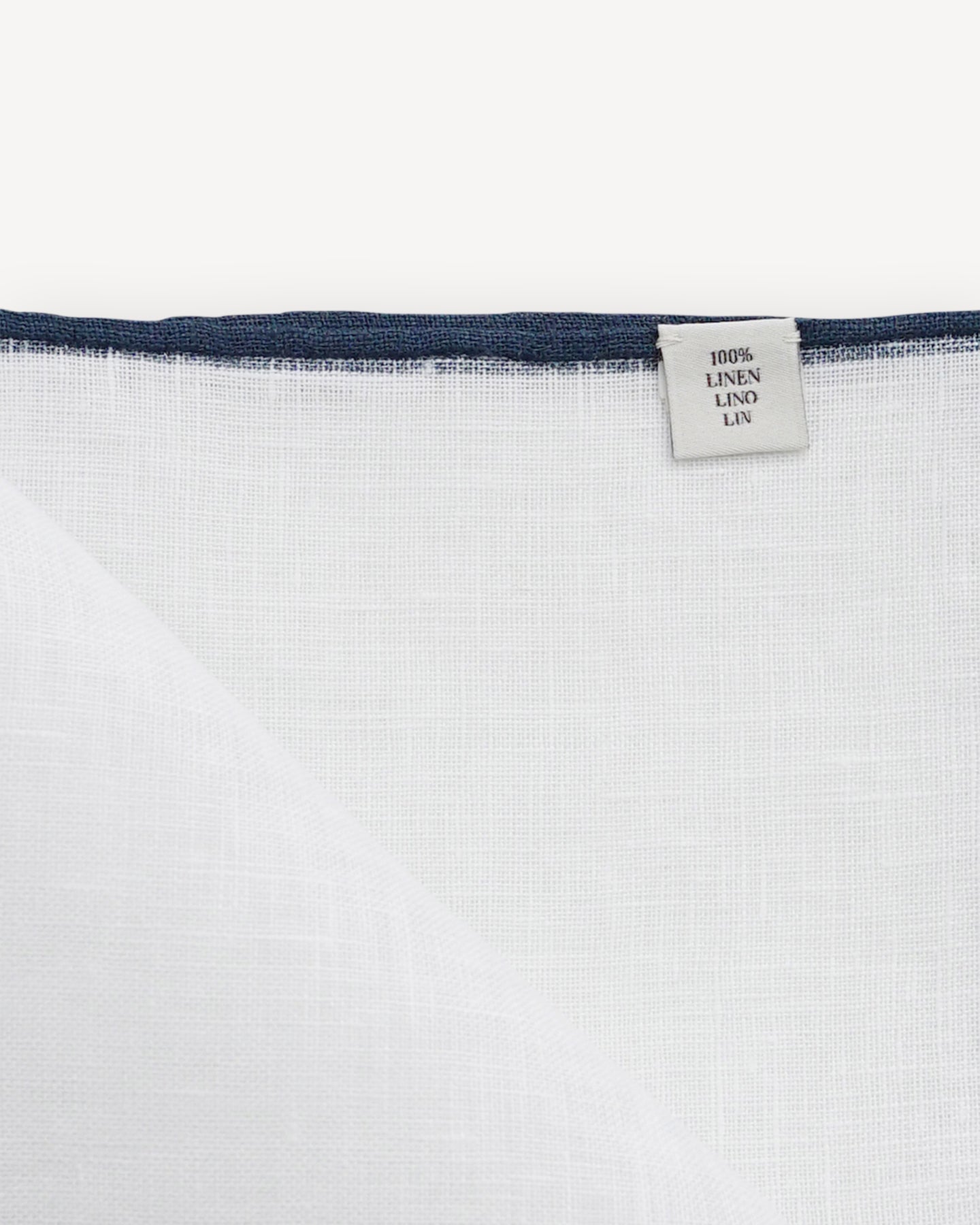 White linen pocket square with navy shoestring