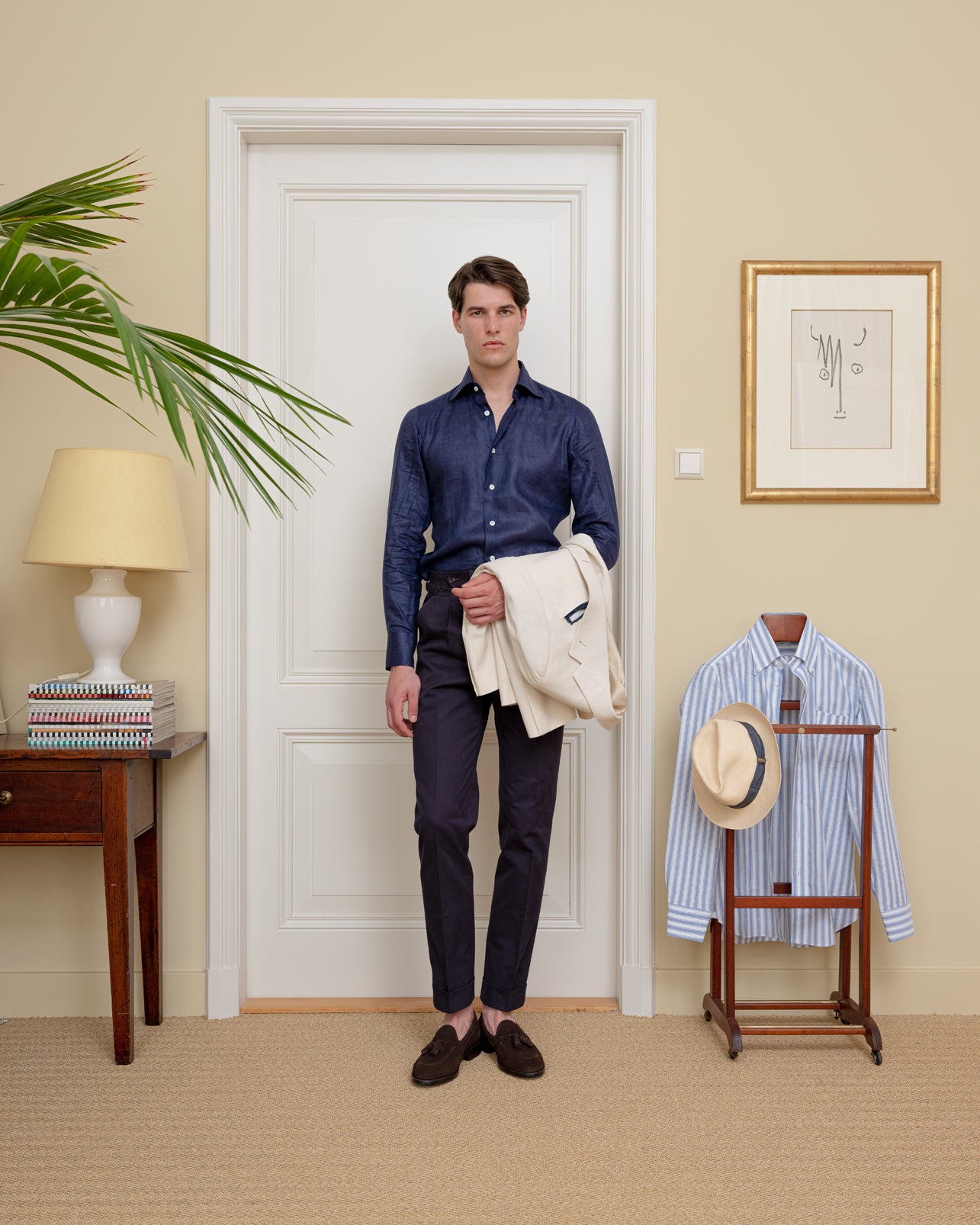 Man wearing a tonal outfit of a navy linen dress shirt combined with navy cotton trousers