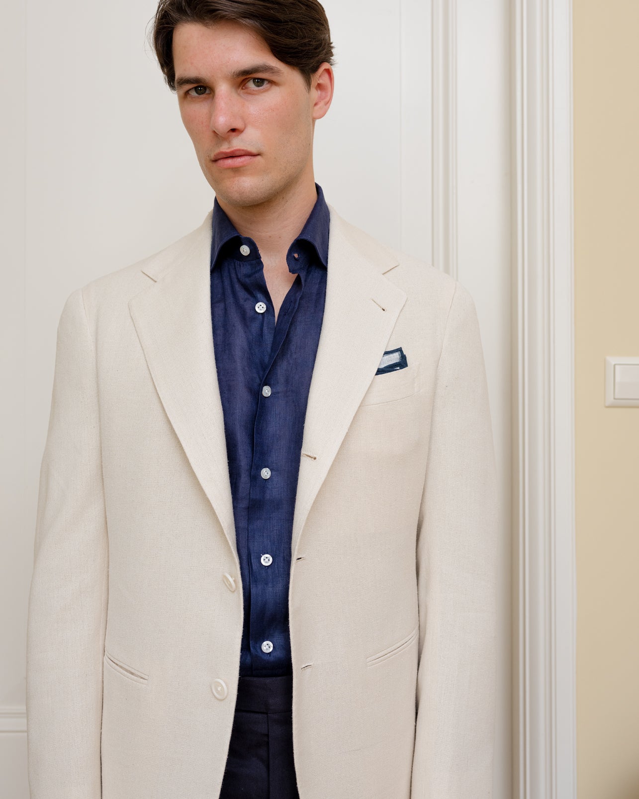 Cream silk sport coat combined with navy linen shirt and navy cotton trousers