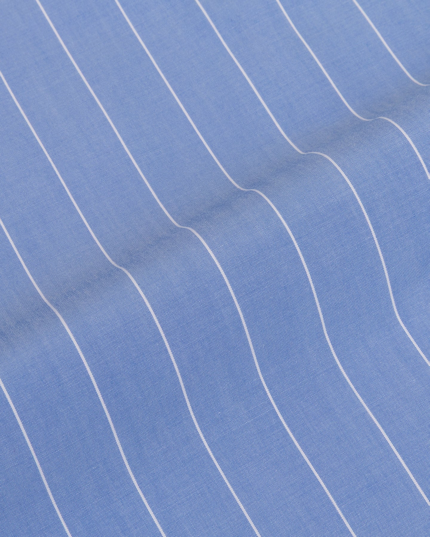 Close-up of blue striped poplin fabric with white pinstripes