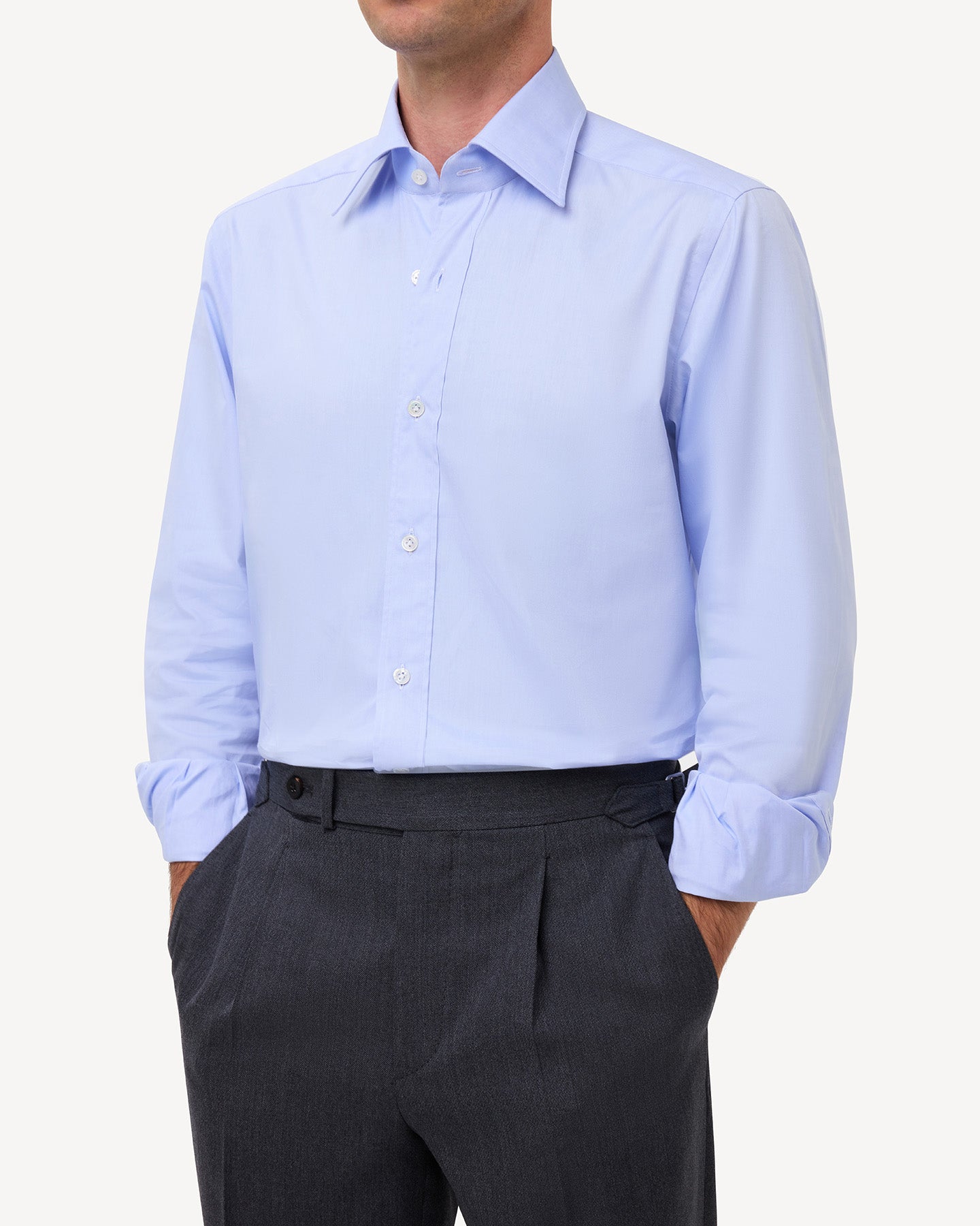 Man wearing a light blue pinpoint oxford shirt with a point collar