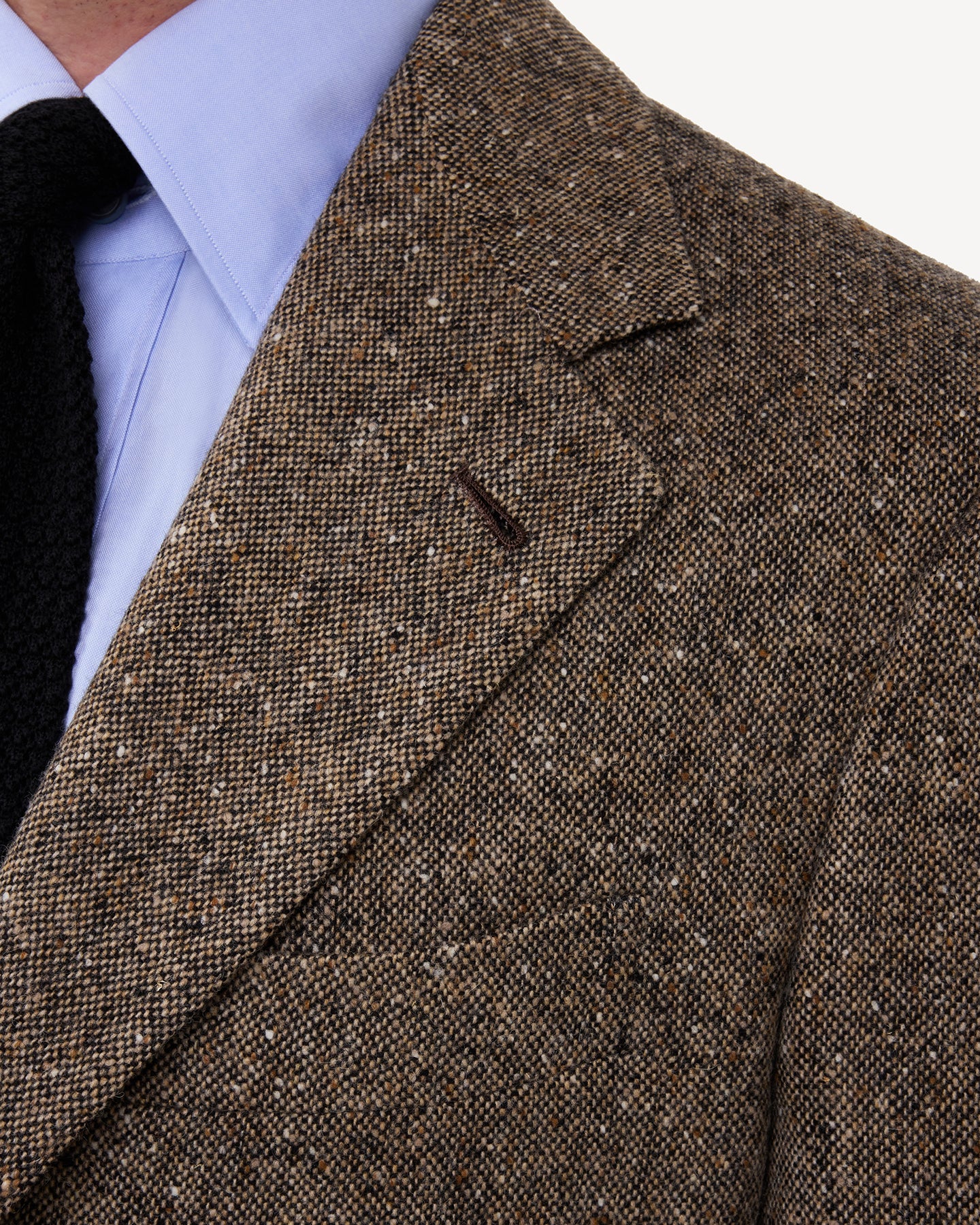 A man wearing a Light Brown Donegal Tweed Sport Coat with notch lapels and handmade buttonhole